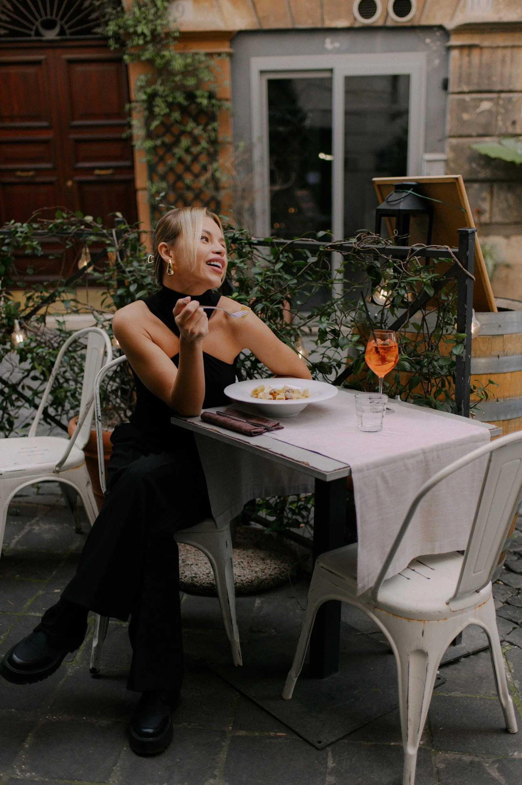 Candid lifestyle moment in Rome with pasta and Aperol capturing authentic Italian atmosphere