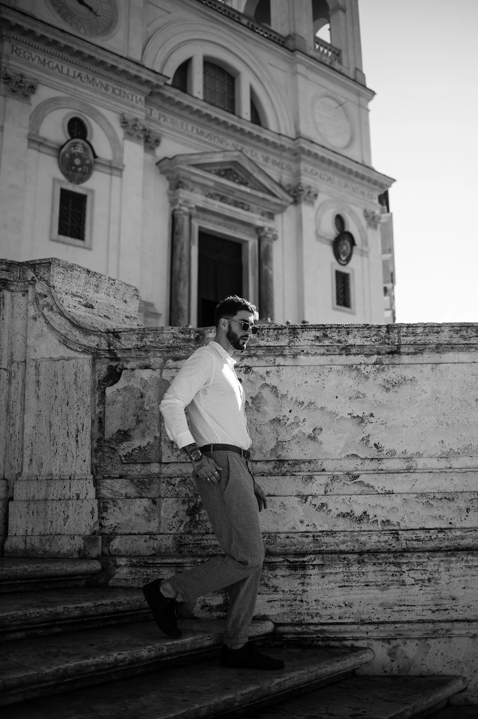 Candid black and white portrait in Rome capturing a man at Spanish Steps