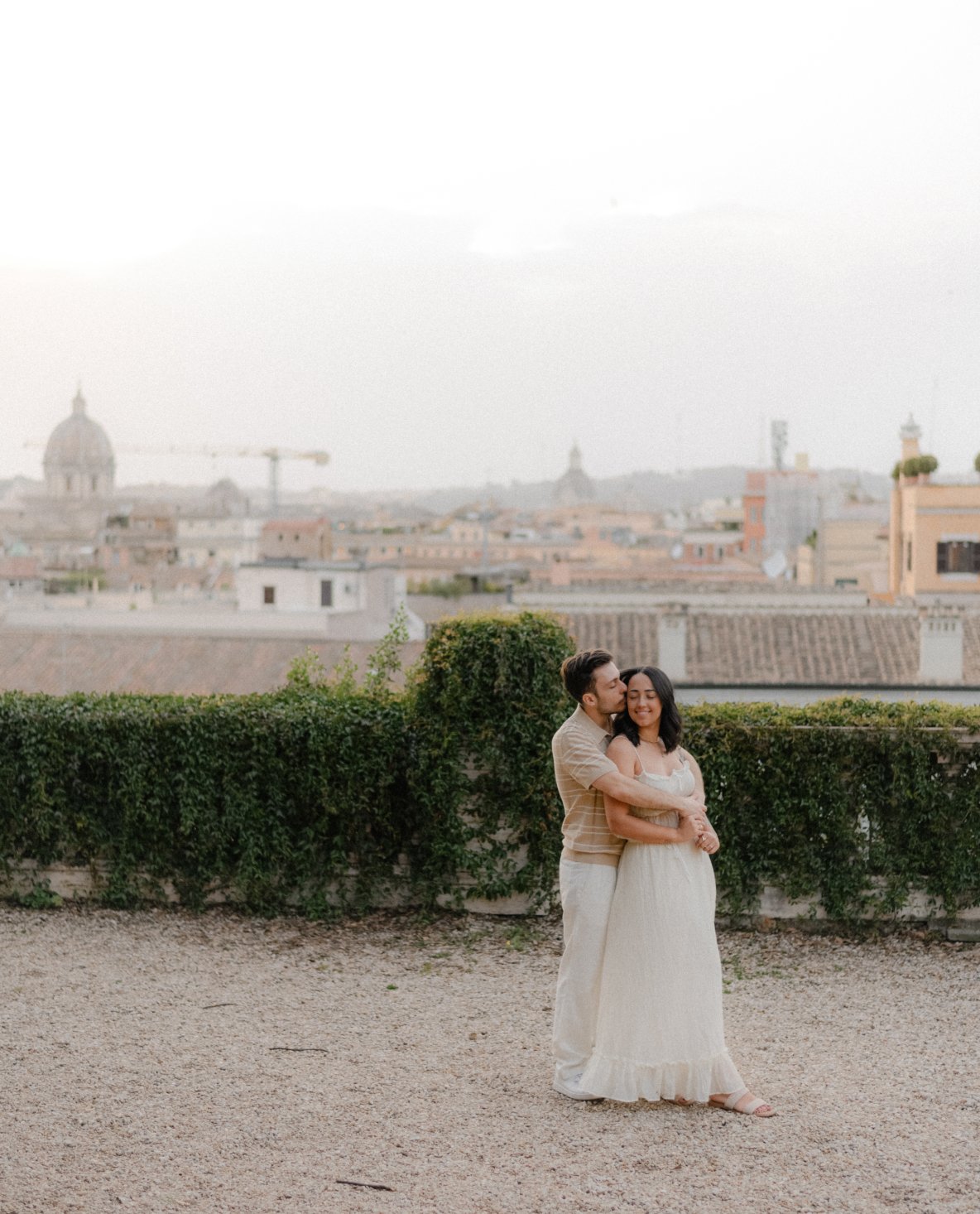 Couple embracing at sunrise in Rome with city view, romantic couple photoshoot