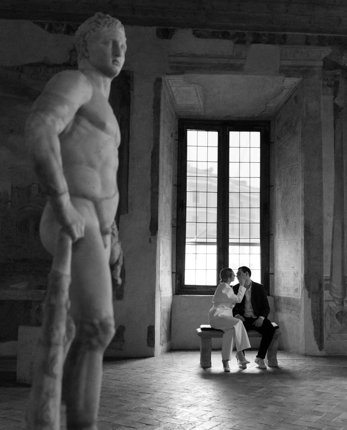 black and white photo of couple in Palazzo Altemps Rome after proposal moment