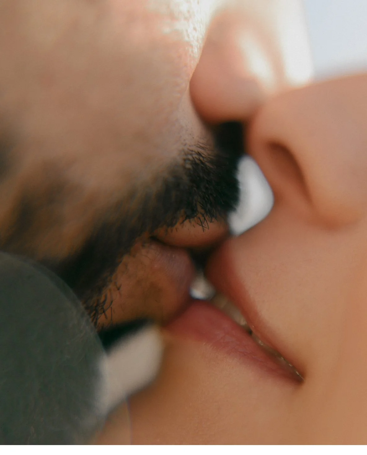 Close-up of two people kissing, showing their lips and part of their noses.