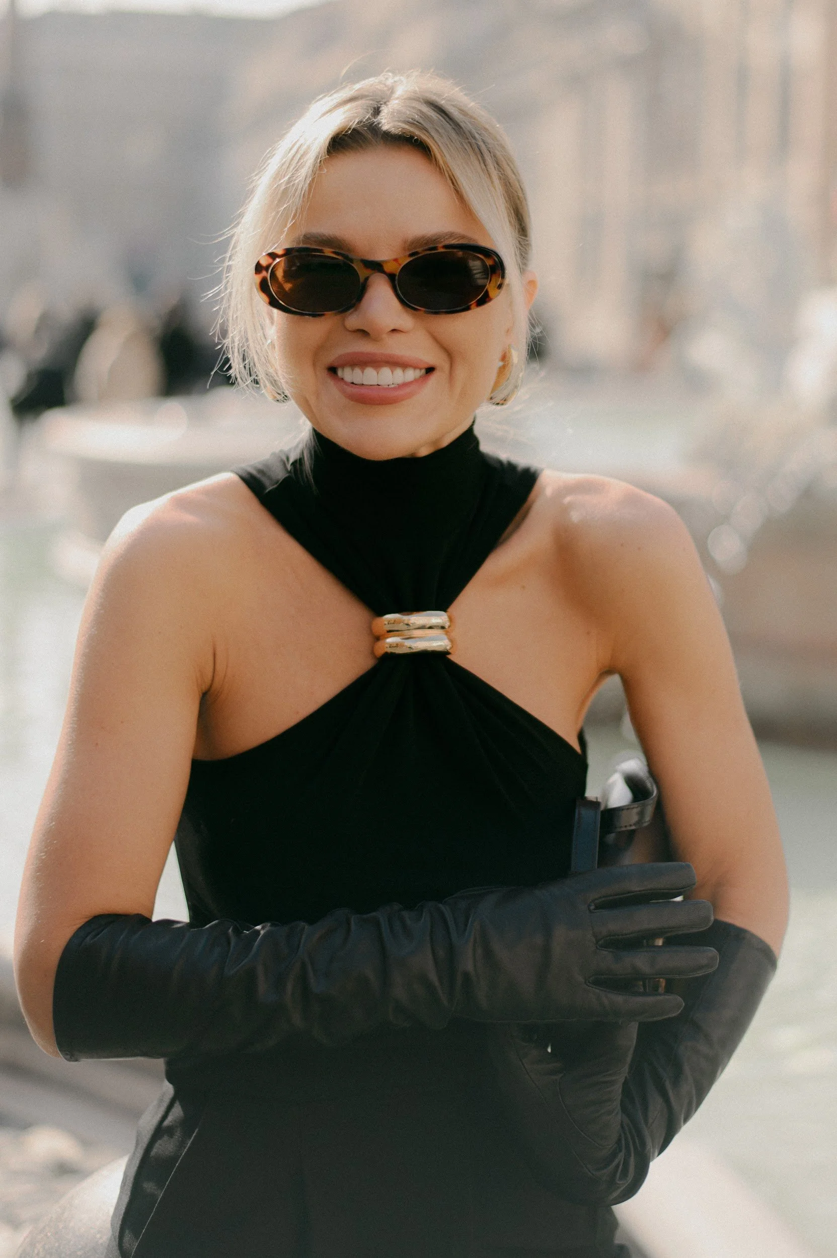 Cinematic fashion portrait in Rome with a woman in black and bold sunglasses