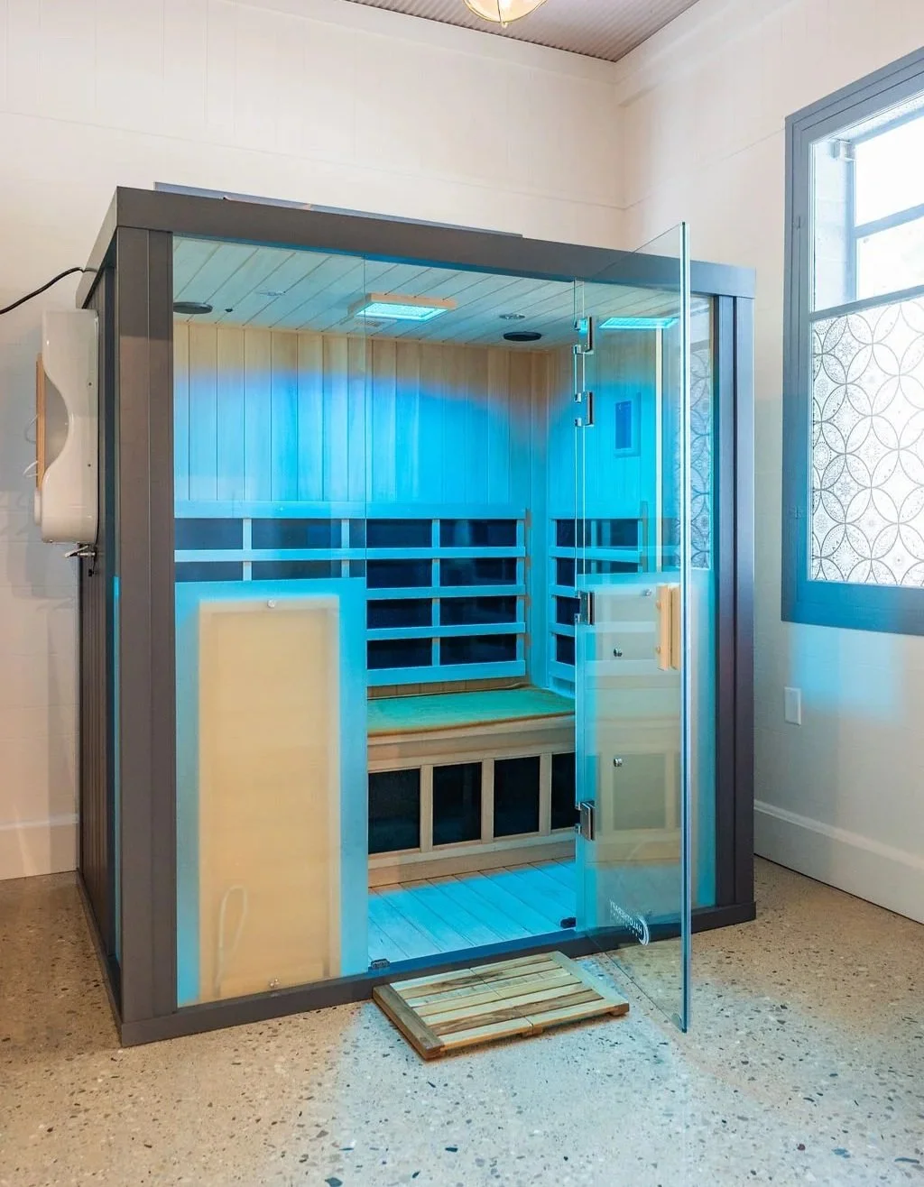 Empty infrared sauna with blue LED lighting.