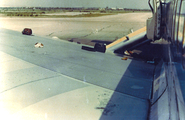 The view from the starboard wing, looking back at R4 with the chute down – hand luggage is strewn across the wing