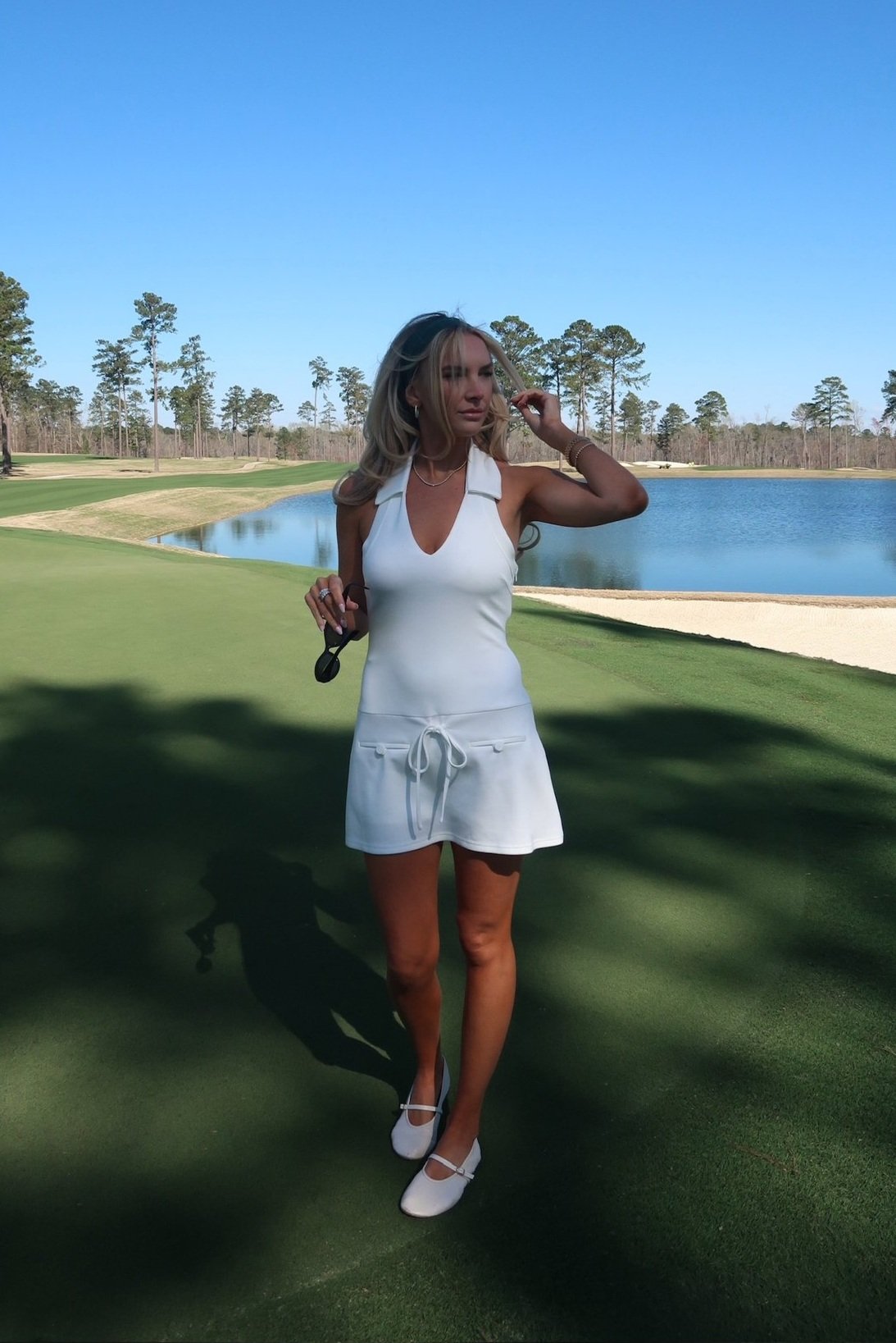 The Fairway Collared Romper in white with a halter top and drop-waist details | House of Duke