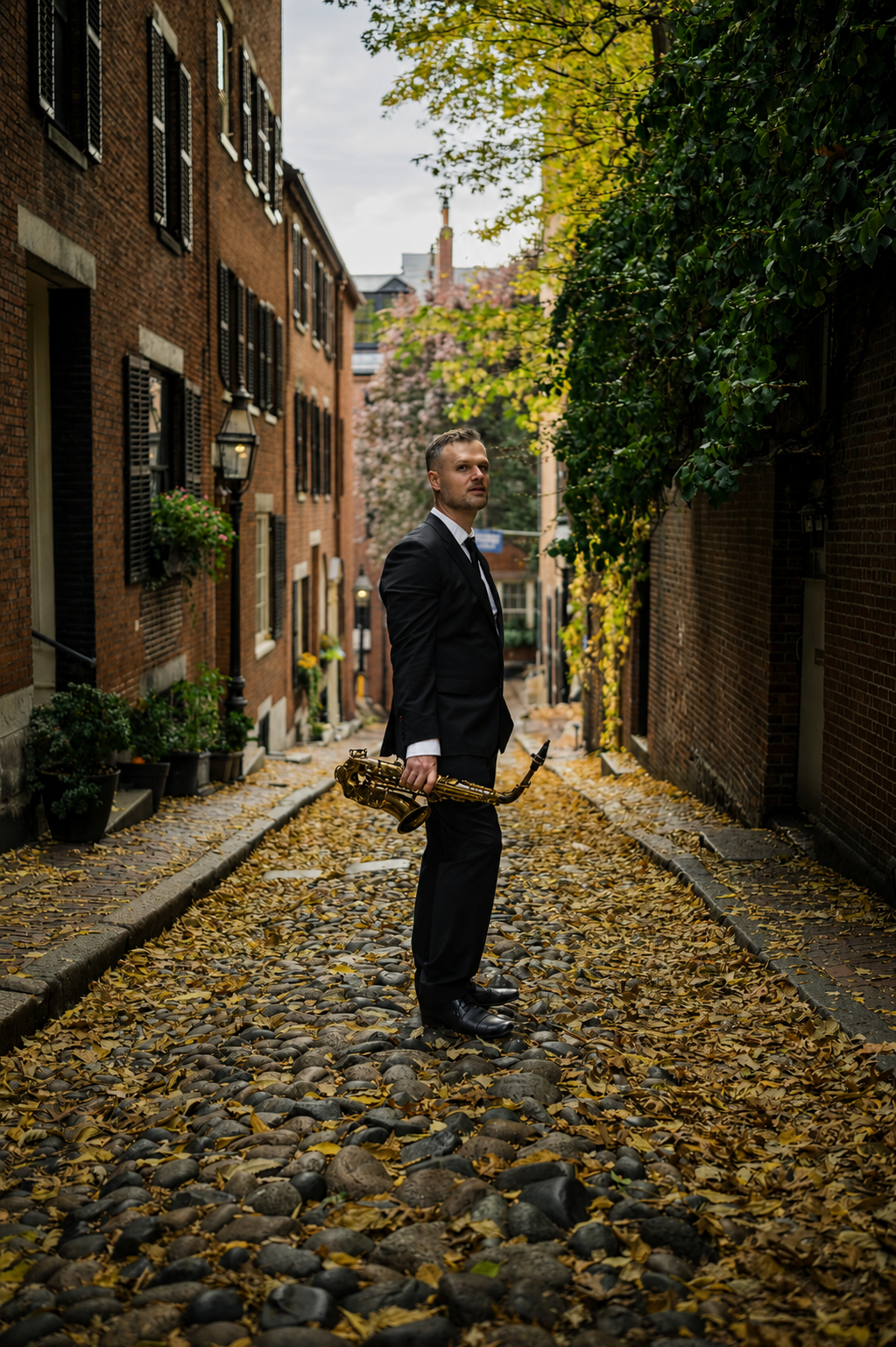 man in black suit with saxophone on a cobbled street