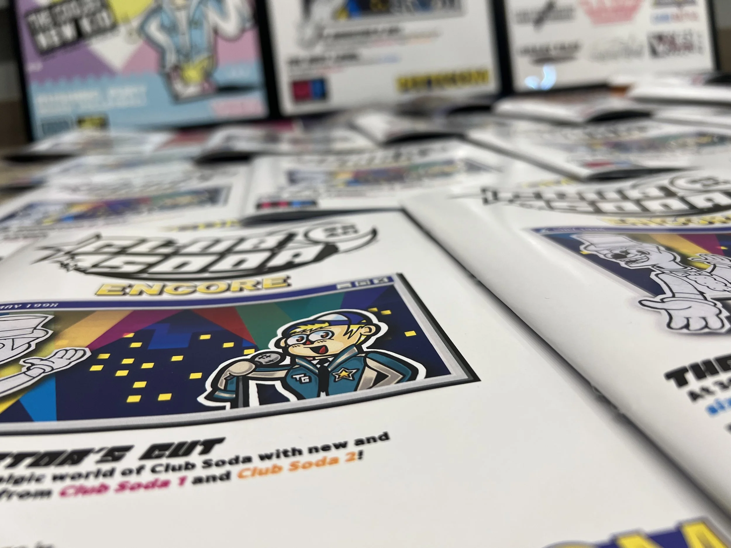A collection of printed out zines layout out for a photoshoot.