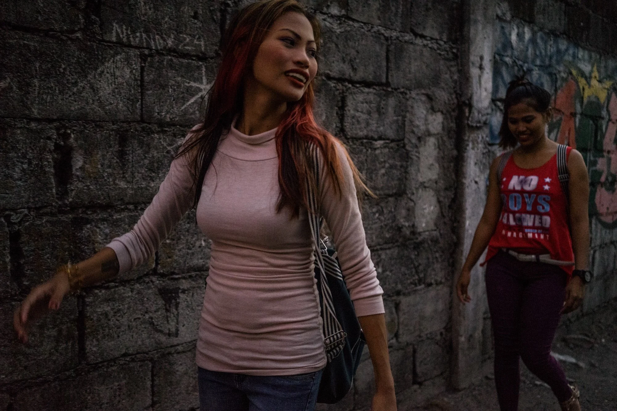 Jojo and Gemma make their way to work. (Photo by Hannah Reyes Morales/GroundTruth)