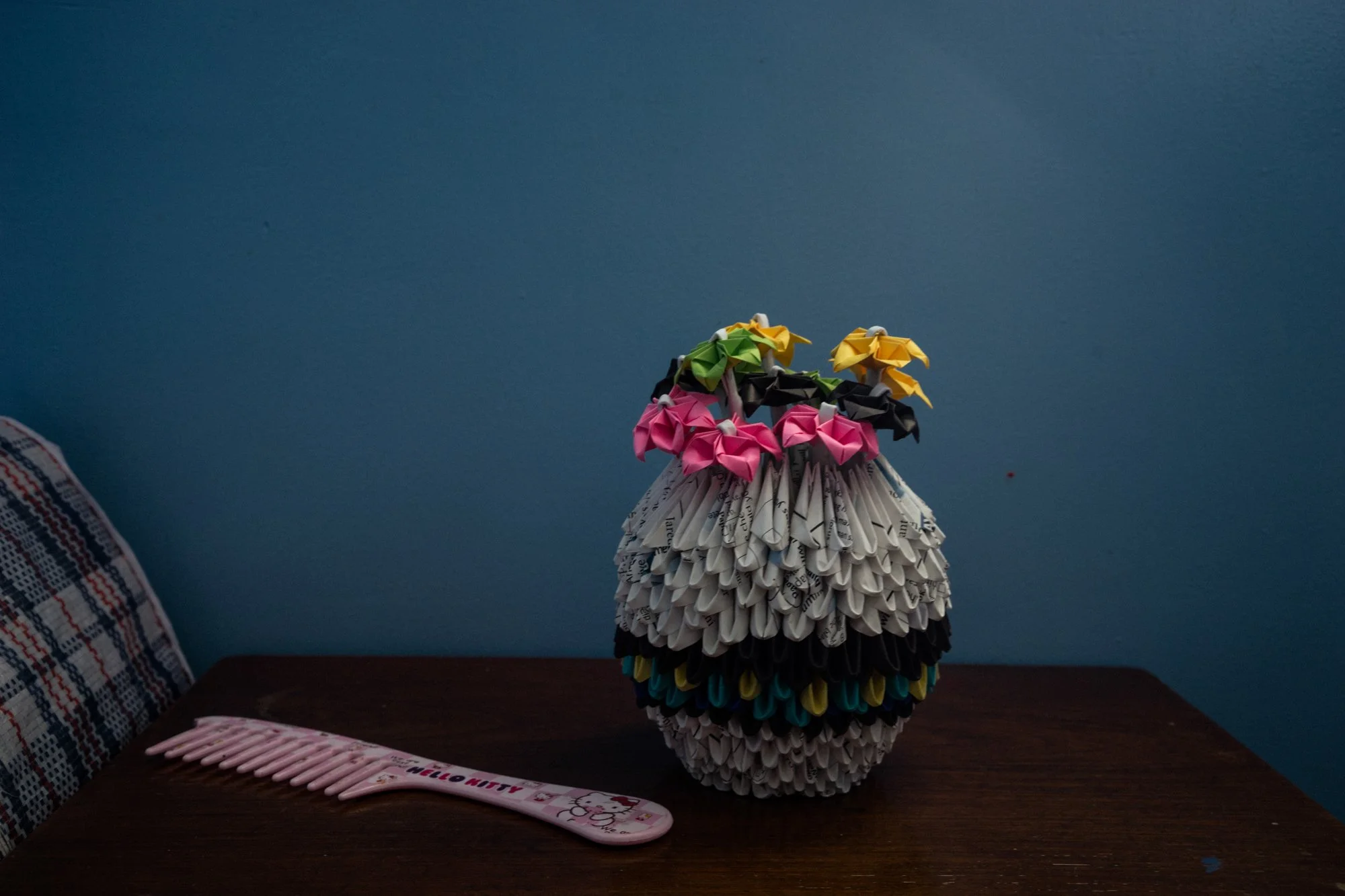 A paper vase of flowers and a comb sit on a table in a Philippine halfway house for victims of sex trafficking. 