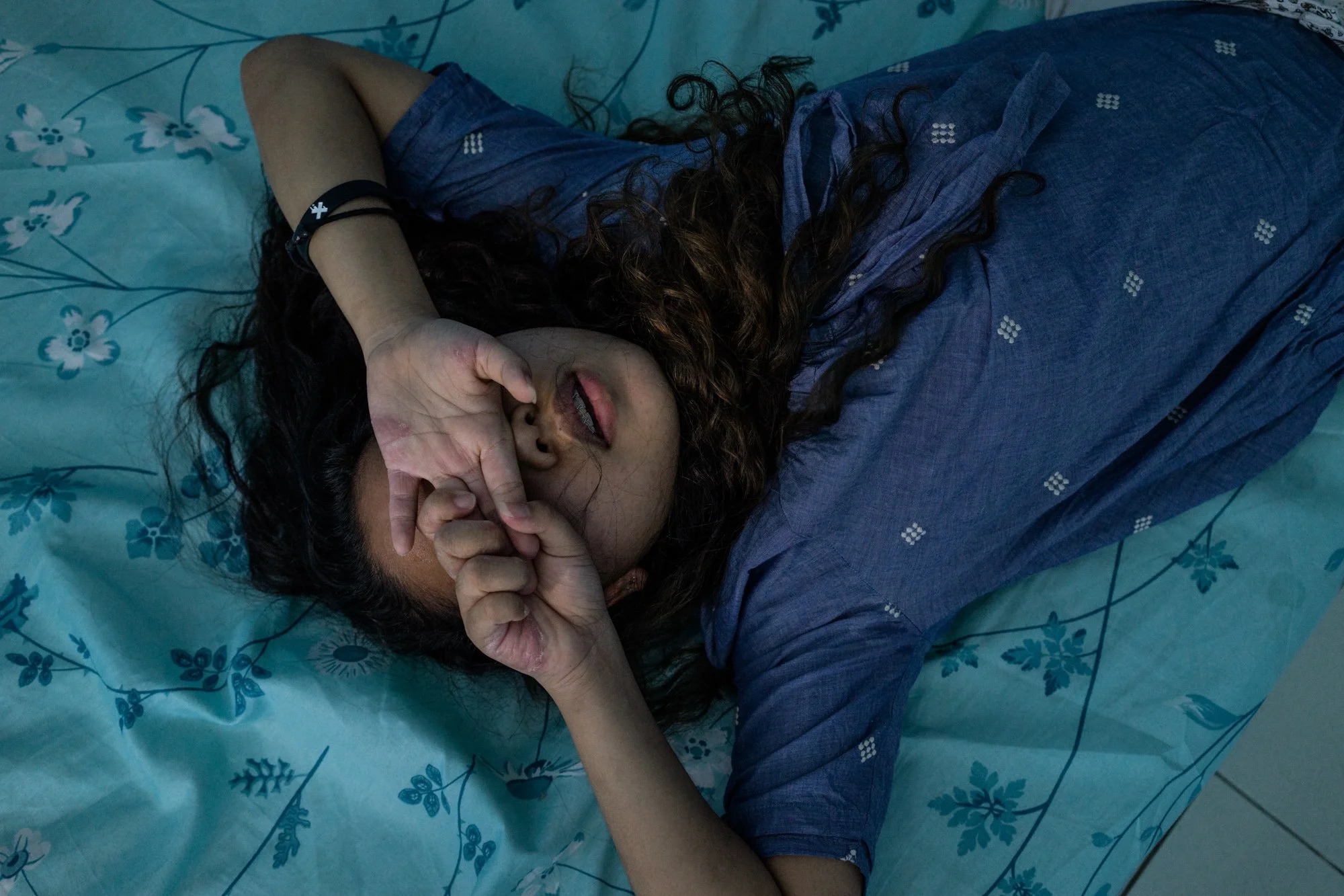 A young girl prays in a room inside a halfway house outside of Manila. 