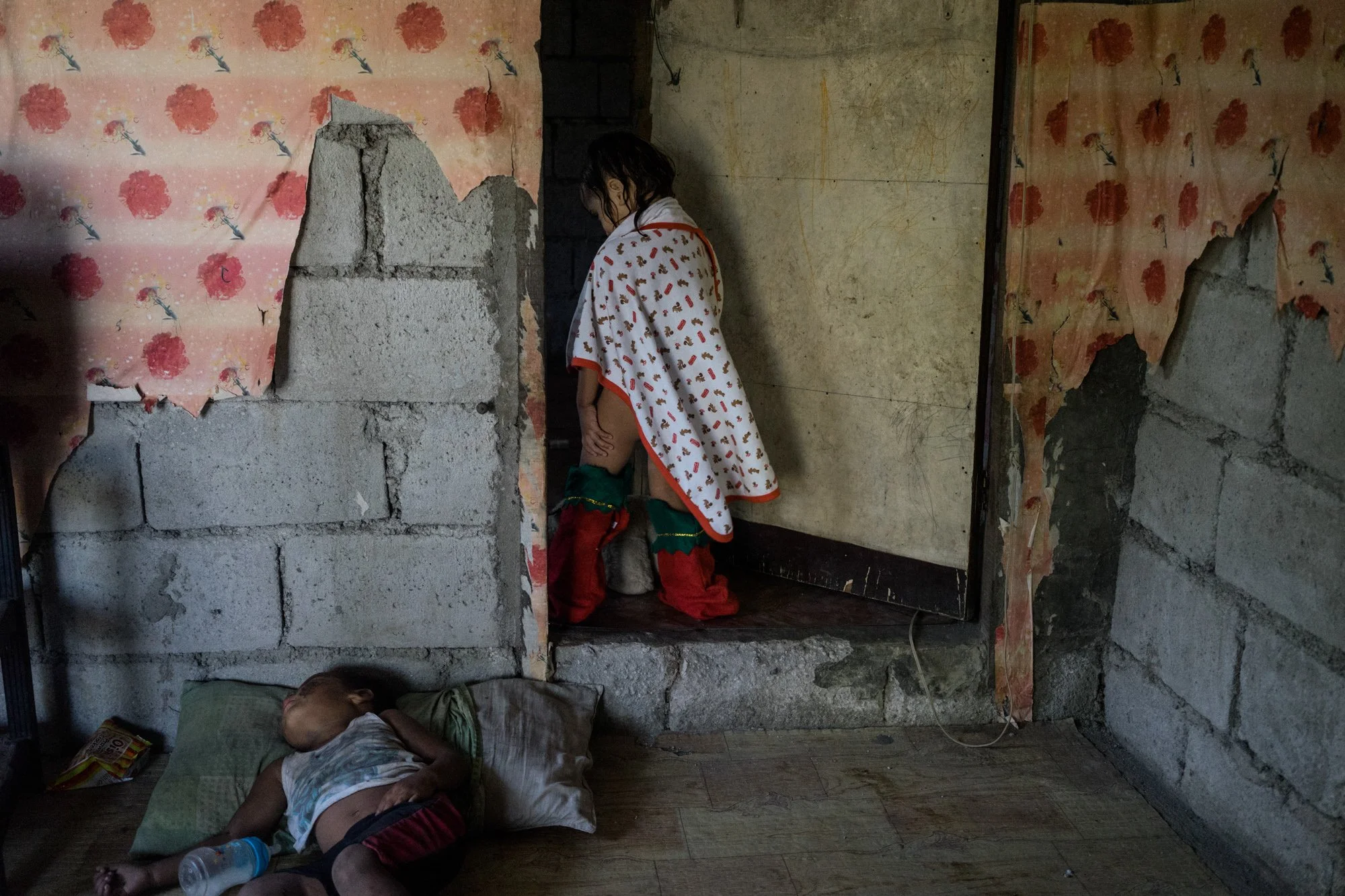 Jojo’s daughter stands in a doorway. Jojo says she dreams that her daughter be a lawyer, so that her “whoring could at least have borne some fruit.” 