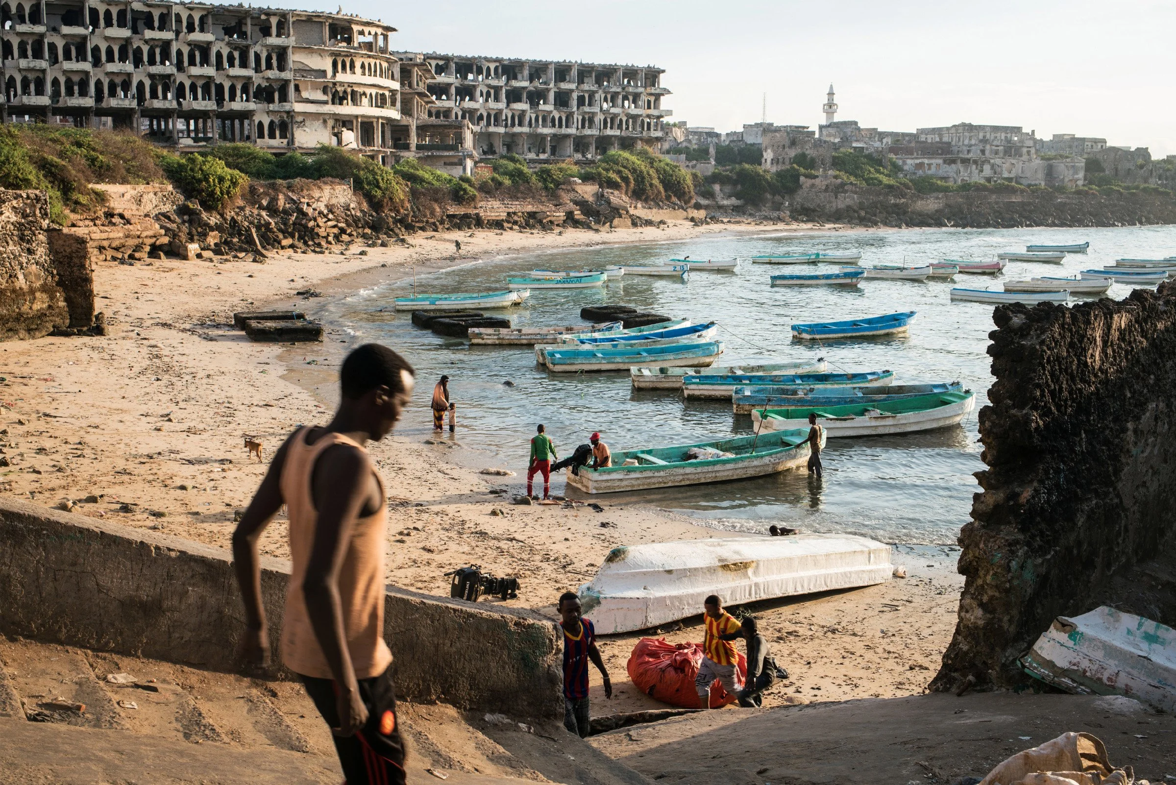 Boats gather at dawn in the old port in Mogadishu, the Somali capital, as fishermen land their catch and ready it for transport to the city’s fish market. 