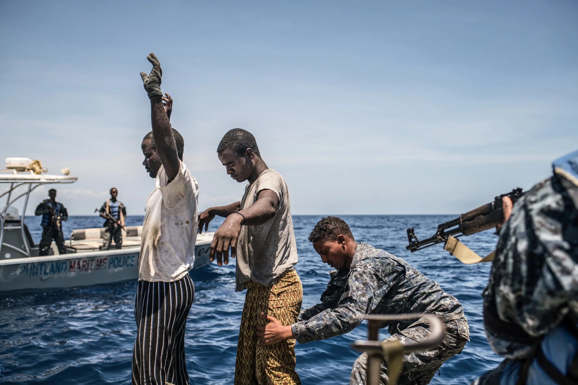 The Puntland Maritime Police Force searches a fishing boat for arms while on patrol off the coast of Bosasso. 