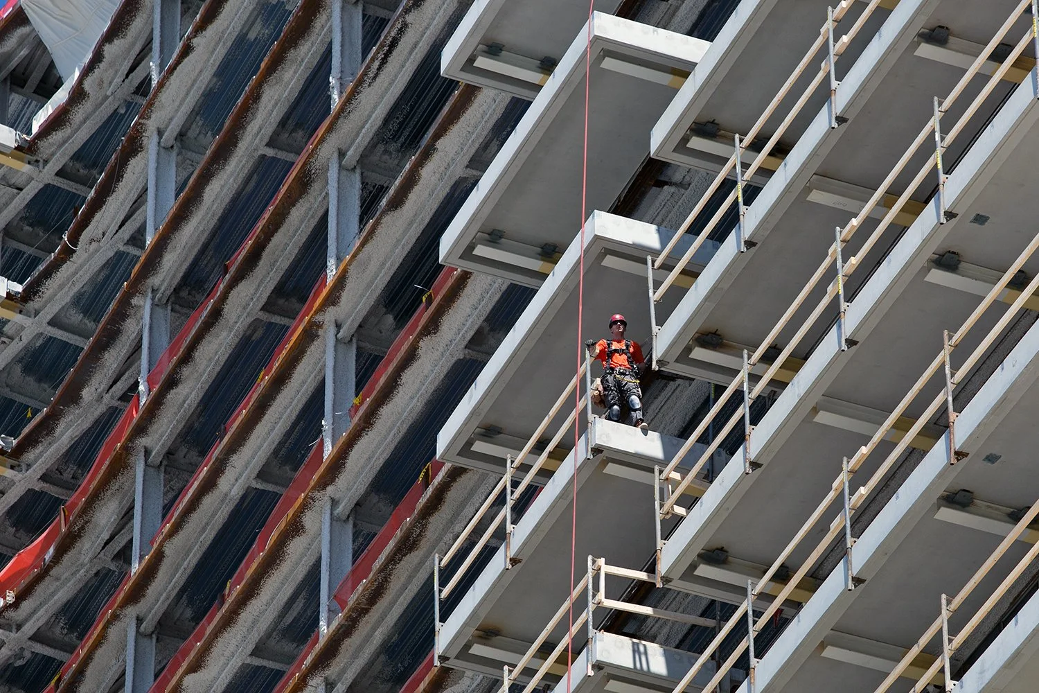 Construction workers are pictured at a development on the South Boston waterfront, June 6, 2016. 