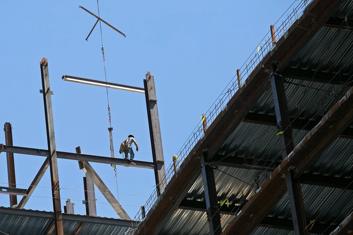 Construction workers are pictured at a development on the South Boston waterfront, June 6, 2016. 