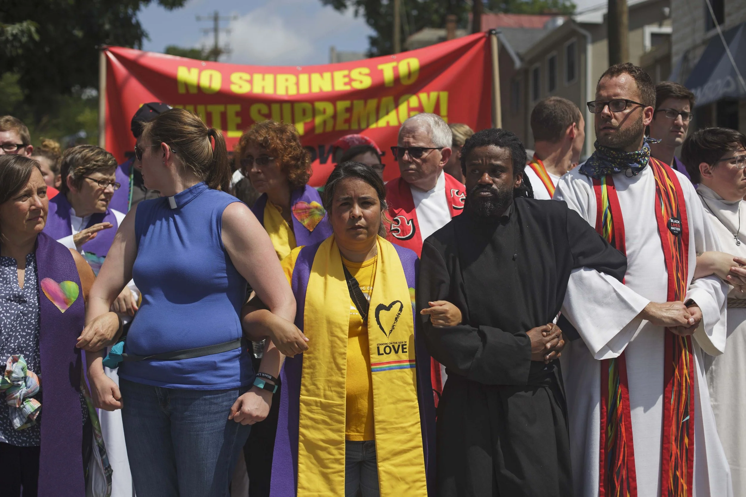  A interfaith group of clergy locked arms on the outskirts of the Unite The Right rally to stand in opposition of white supremacy. August &nbsp;12, 2017, Charlottesville, VA. (Shay Horse/GroundTruth) 