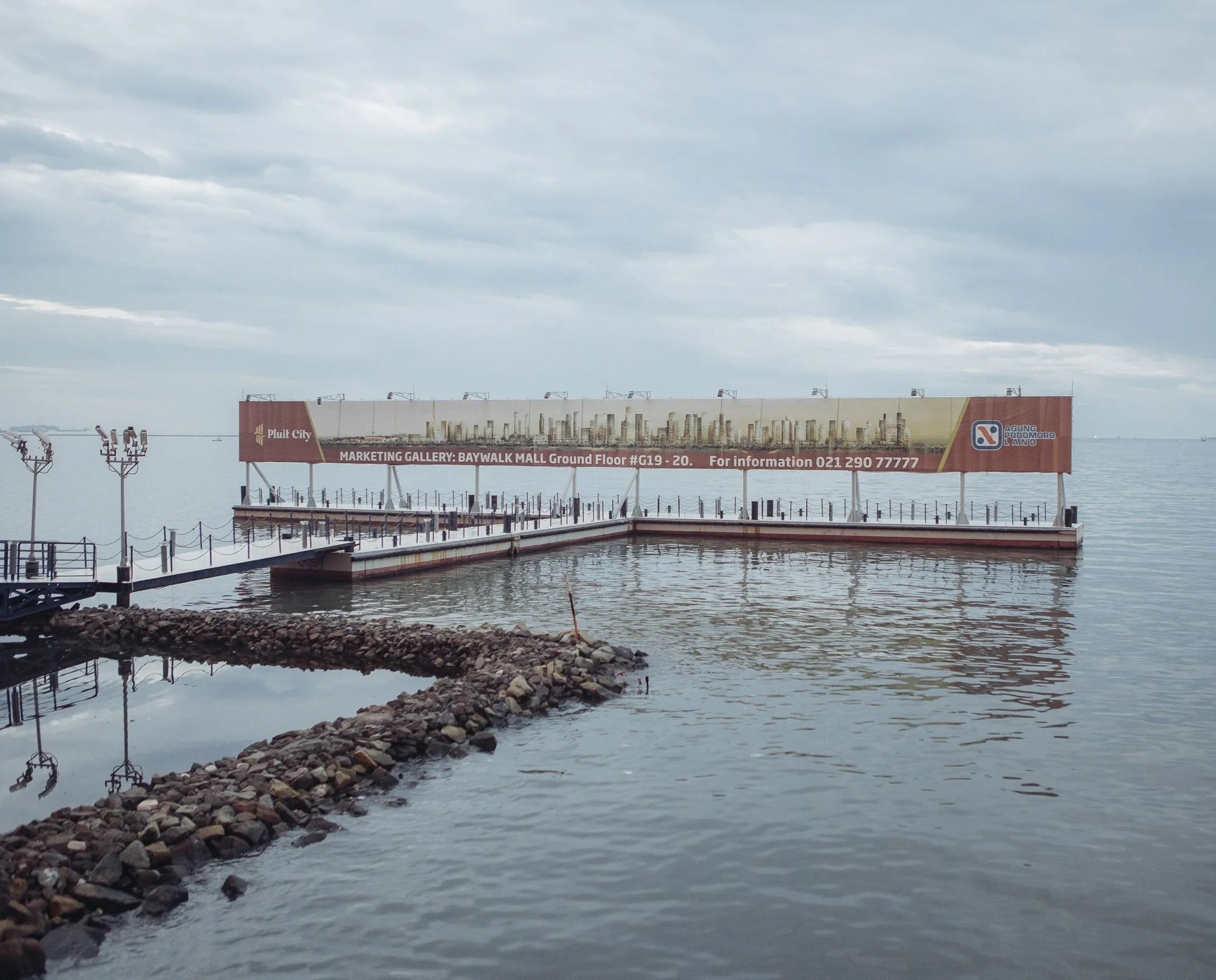 A giant billboard at a mall in North Jakarta advertises the so called “waterfront city.” It is planned to be built on an artificial island that does not exist yet. 