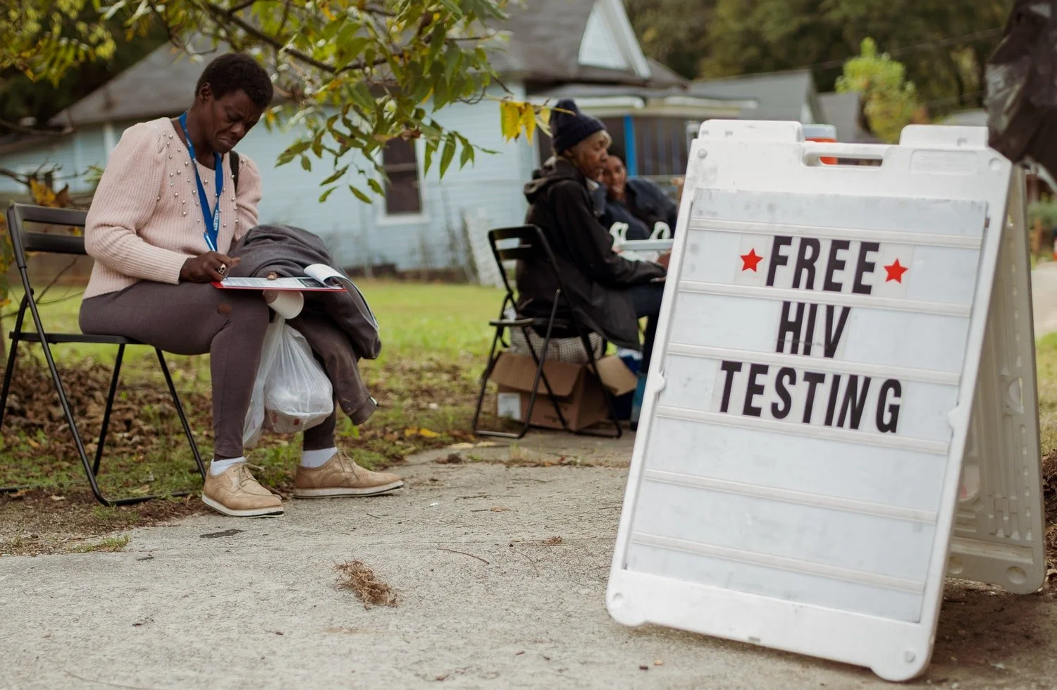  Clotele Davis waits for a free HIV test at Atlanta Harm Reduction’s weekly needle exchange and mobile testing event. The CDC estimates the lifetime cost of treating one HIV patient is more than $400,000 and that people who inject drugs are five time