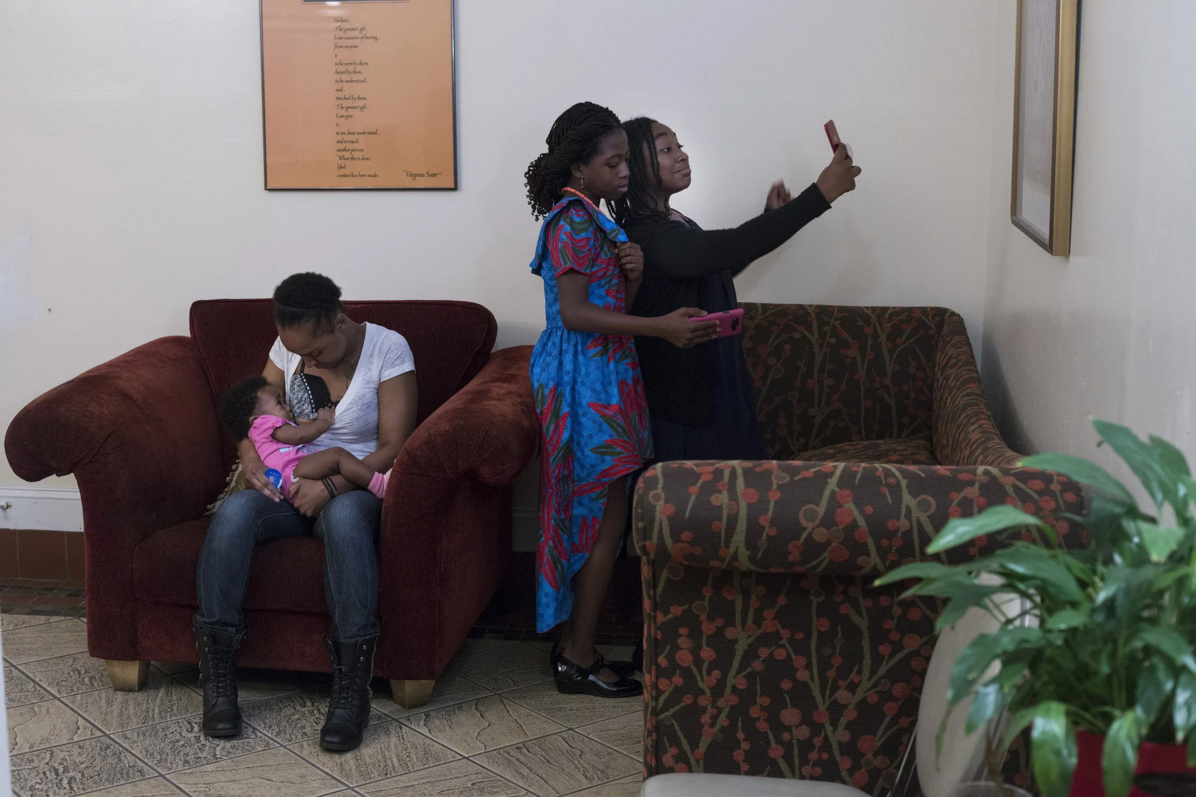  Lori Goss, 27, of Pleasant Hill, breastfeeds her daughter as Jada Byrd, 10, (left) and Adaora Amachree, 10, (right) pose for Snapchat during a luncheon at the Third Baptist Church in the Fillmore district of San Francisco, California, on Sunday, Nov