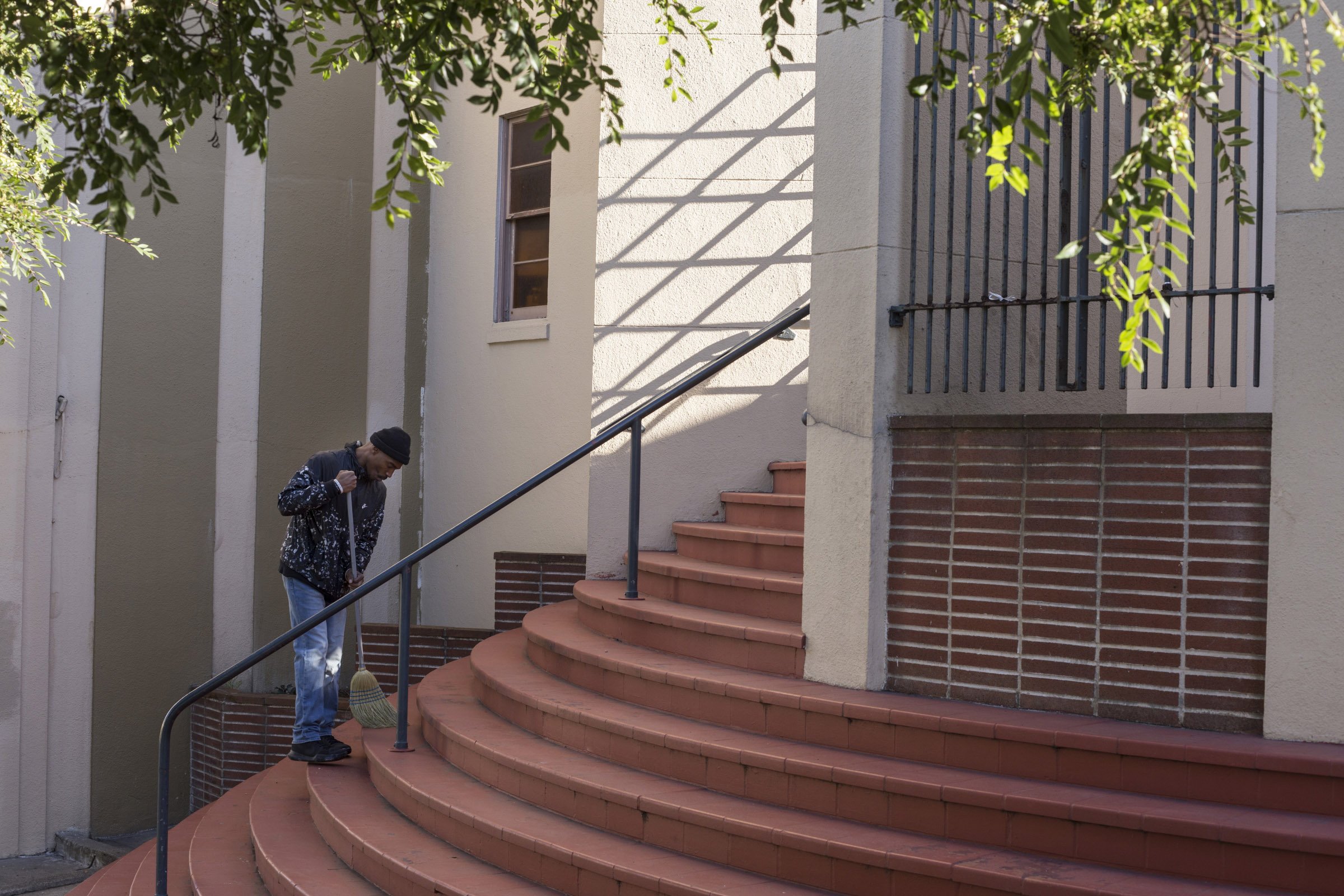  Fred Thomas Jr., 28, sweeps the steps of the Third Baptist Church in the Fillmore District of San Francisco, California, on Tuesday, November 7, 2017. (Photo by Brittany Greeson) 