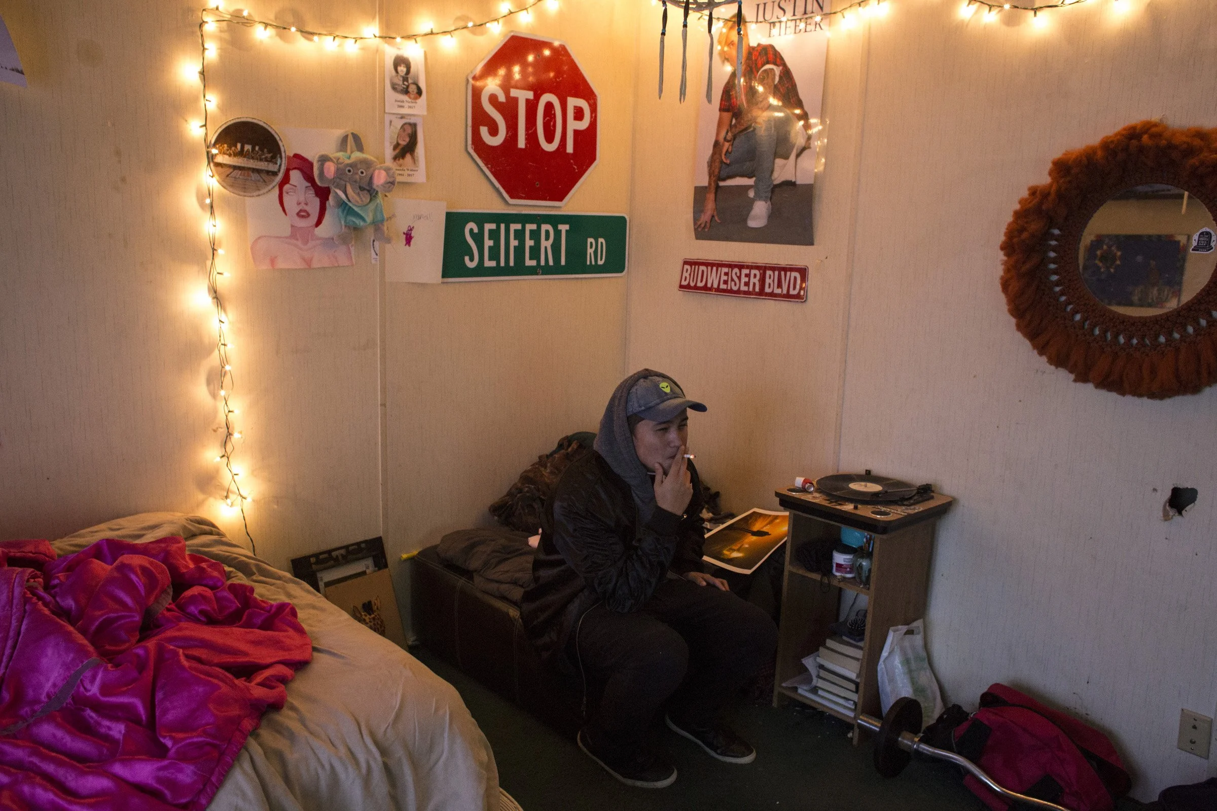  Xavier Smith, 17, smokes a cigarette in his room in Pablo, Montana, a town on the eastern edge Flathead Reservation, on Saturday, October 21, 2017. (Photo by Brittany Greeson) 