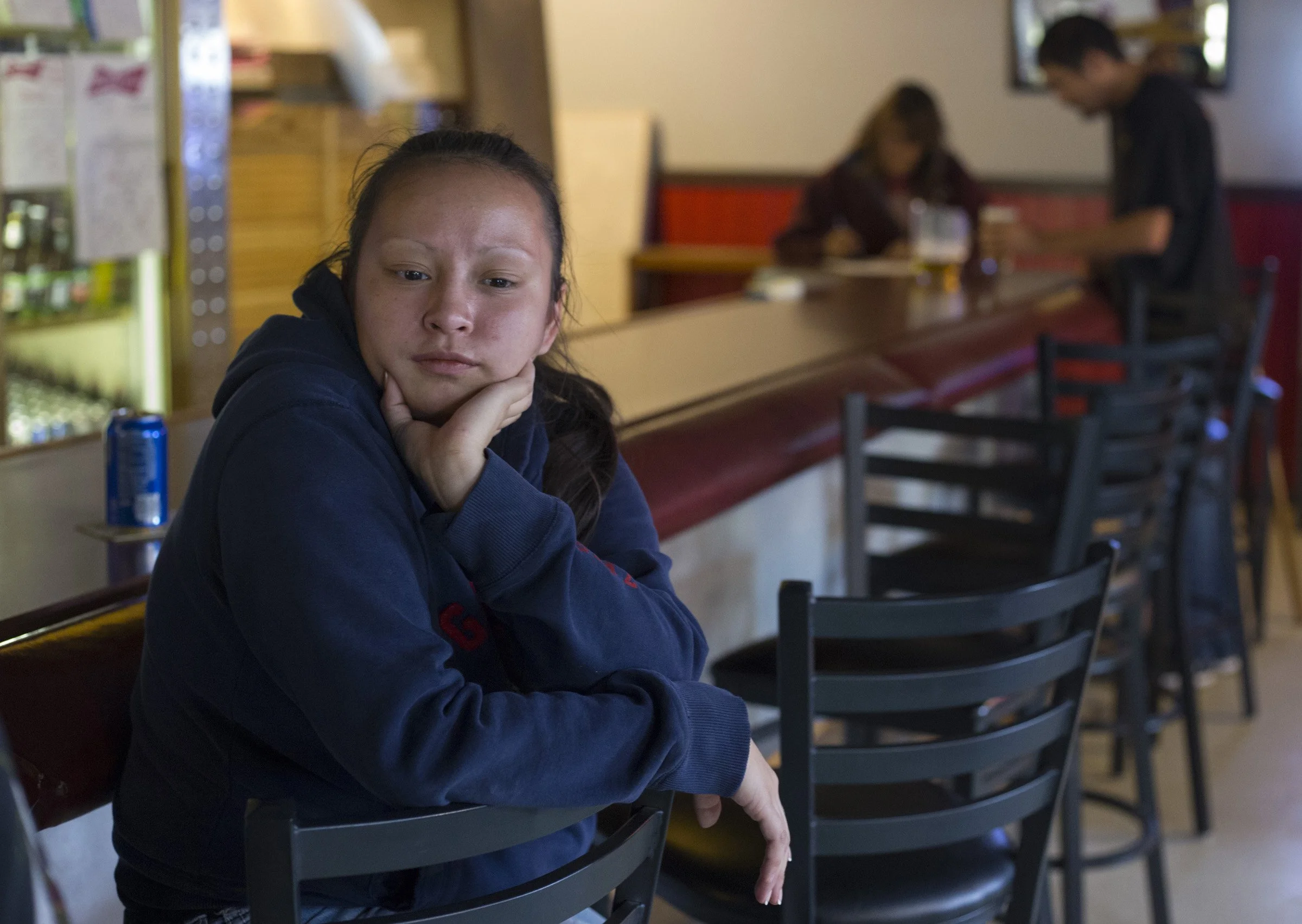  Adele Frost, 25, waits by the bar as her boyfriend plays a round of pool in Pablo, Montana, on Sunday, October 22, 2017. (Photo by Brittany Greeson) 