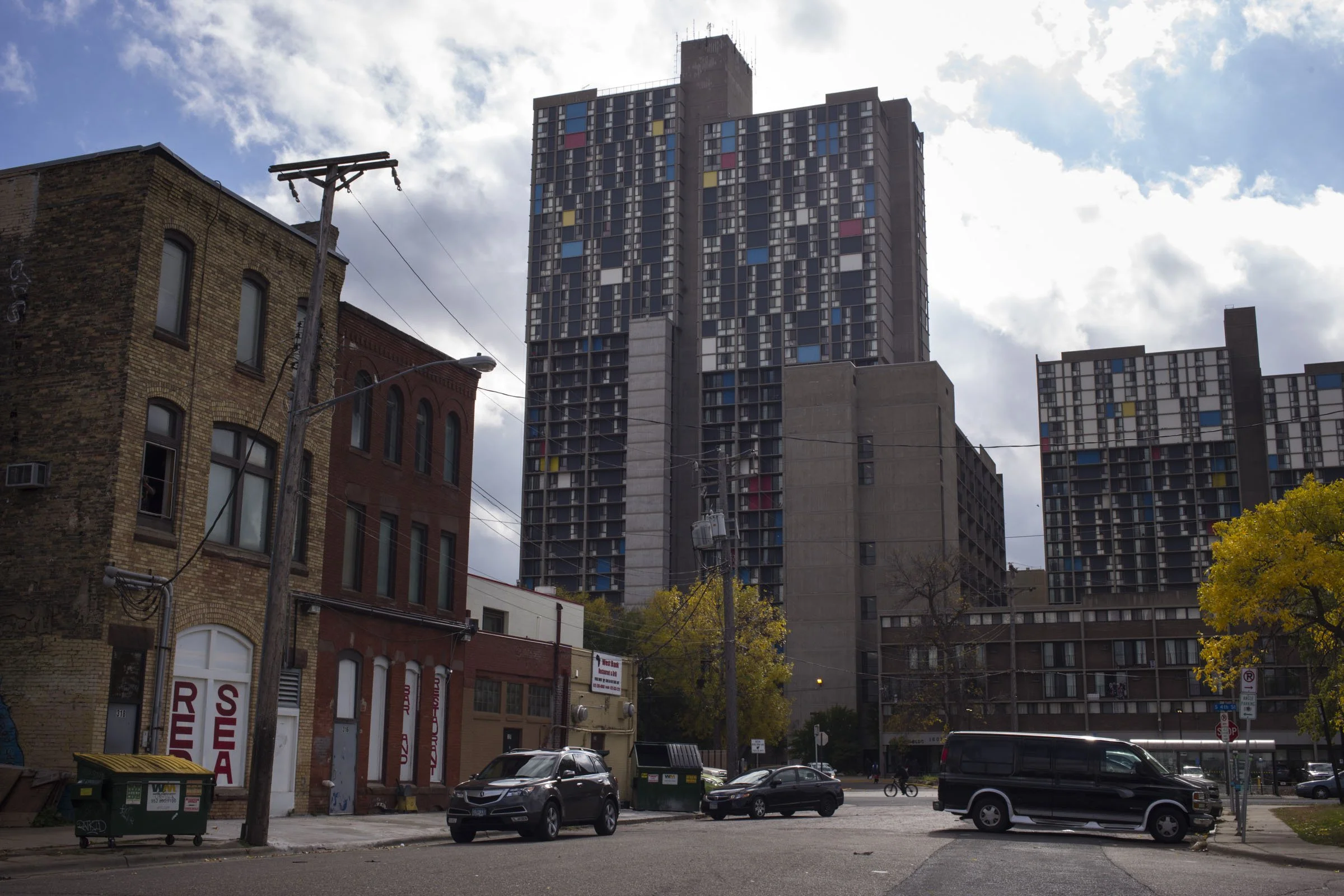  An apartment building towers over shops in the Cedar-Riverside neighborhood of Minneapolis, Minn., on Thursday, October 12, 2017. (Photo by Brittany Greeson) 