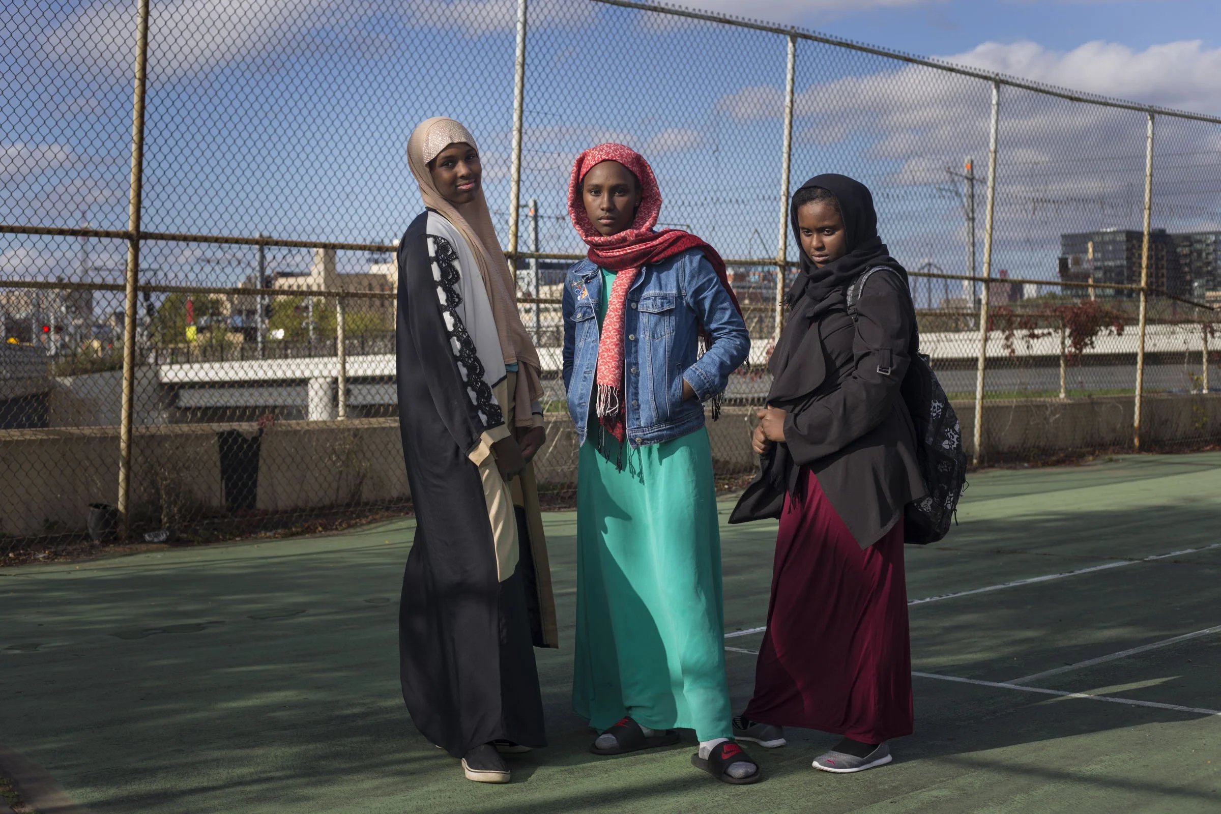  From left to right, Maryam Warsame, 13, Nada Tohu, 13, and Ikran Ibrahim, 12, outside of the Brian Coyle center in the Cedar-Riverside neighborhood of Minneapolis, Minn., on Thursday, October 12, 2017. (Photo by Brittany Greeson) 