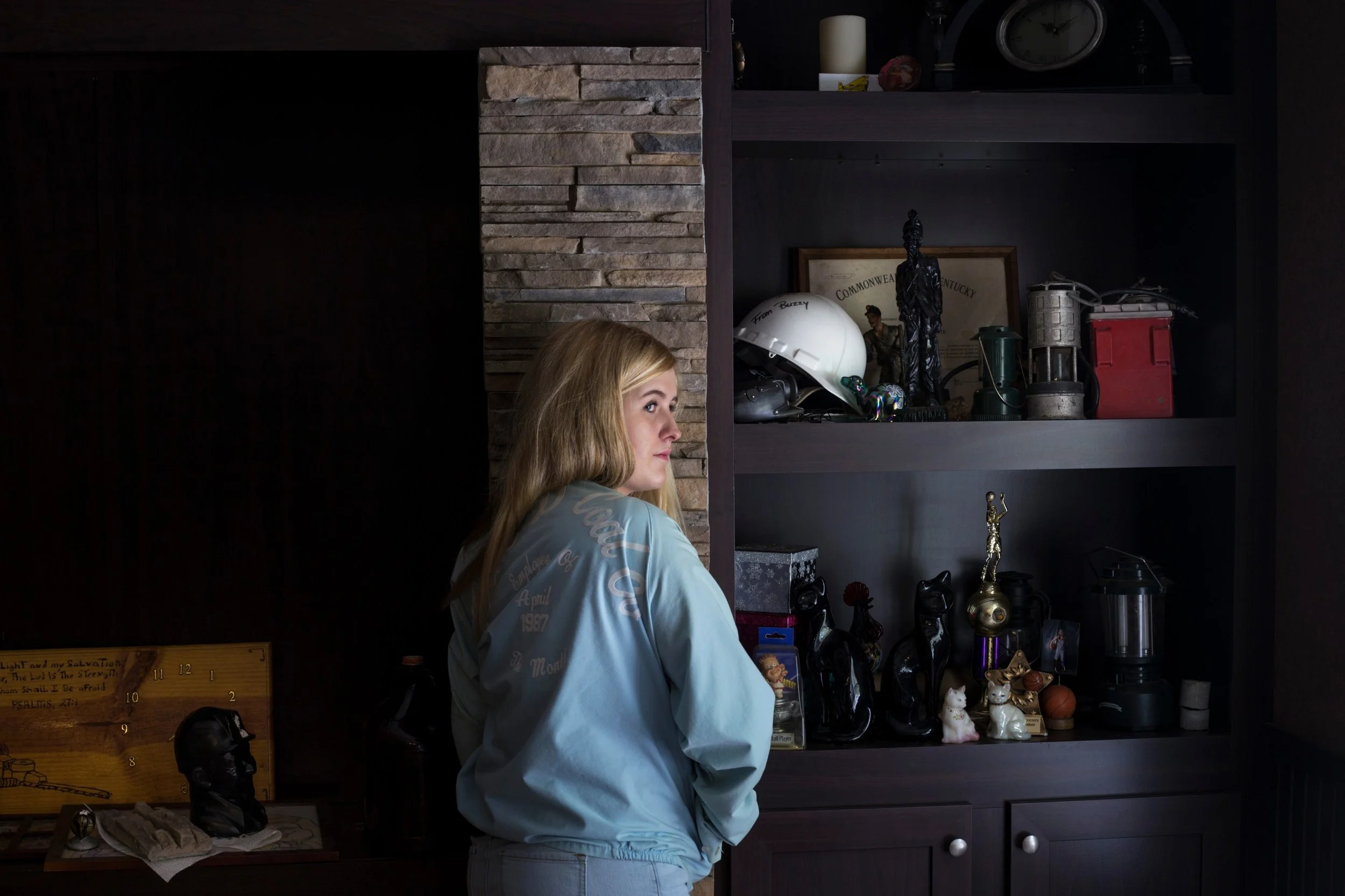  Lizzie Jones, 17, proudly wears her father’s employee of the month jacket from his time working at the coal mines nearby a shelf of her family’s relics of the coal industry at her home in Eastern Kentucky, on Sunday, September 24, 2017. Jones’ fathe