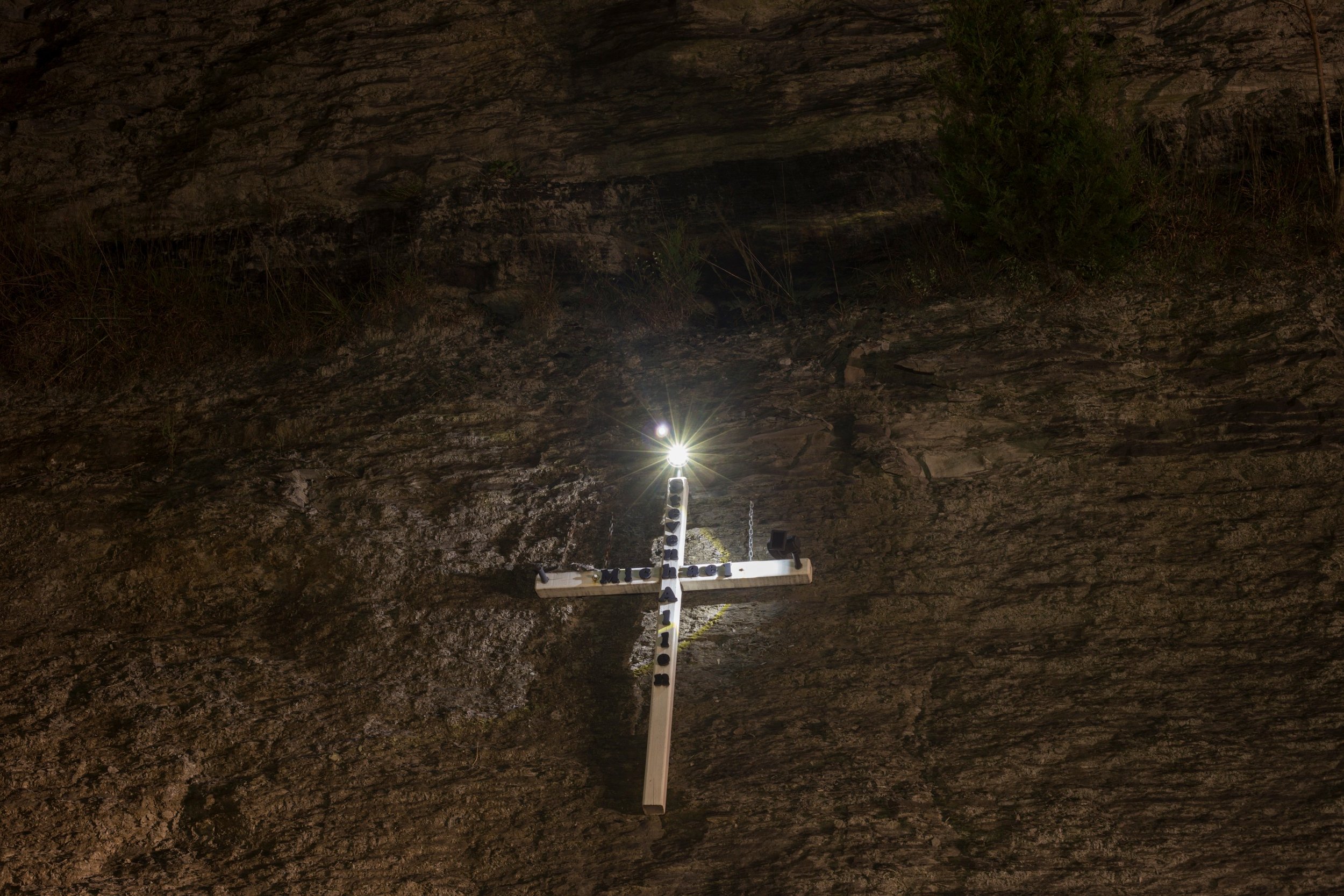  A cross in honor of a man named Steven Michael Allen is nailed into a wall of rock along I-23 near Tram, Kentucky, on Sunday, September 23, 2017. (Photo by Brittany Greeson) 