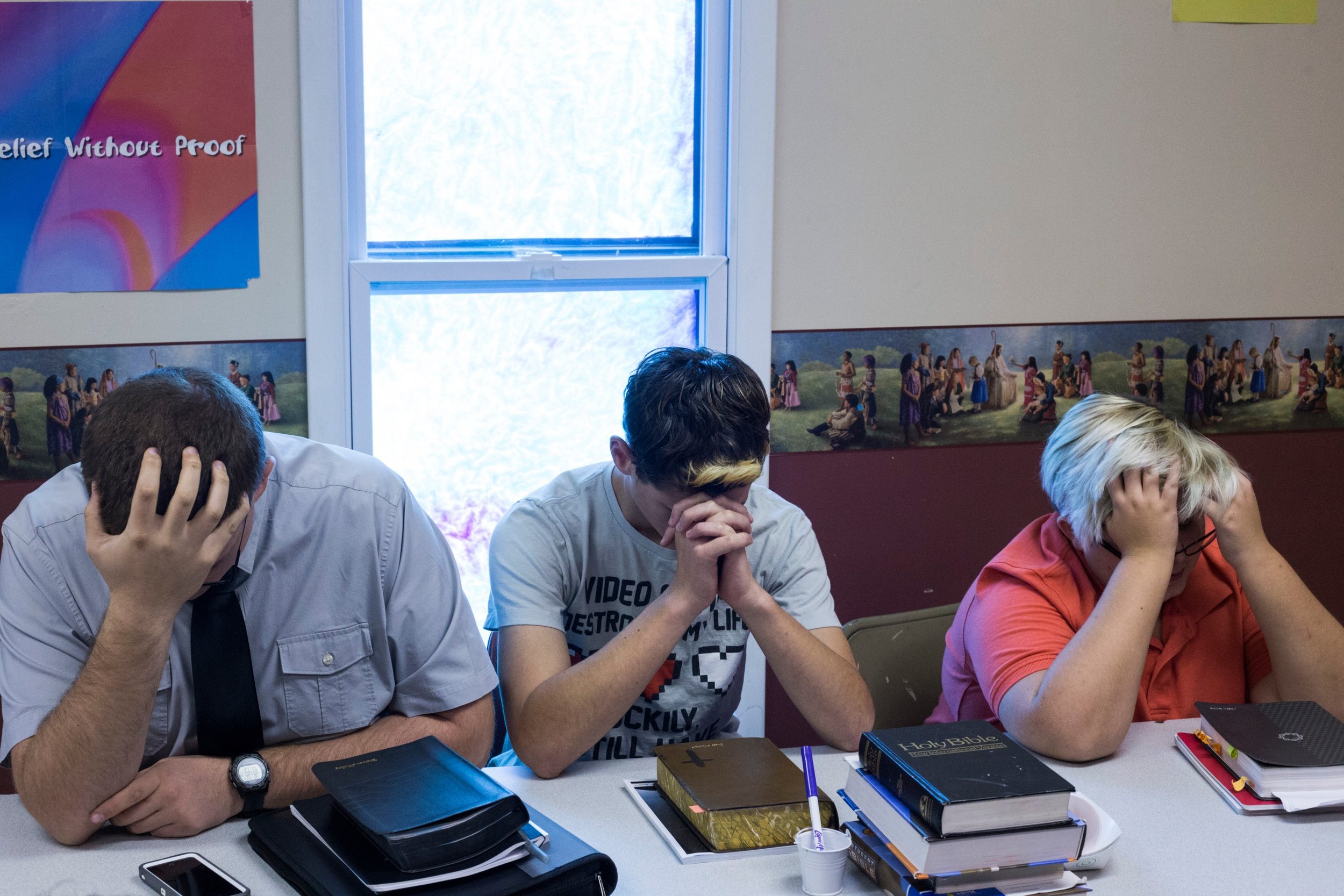  Students bow their heads to pray during Sunday school at the First Baptist Church in McDowell, Kentucky, on Sunday, September 24, 2017. (Photo by Brittany Greeson) 