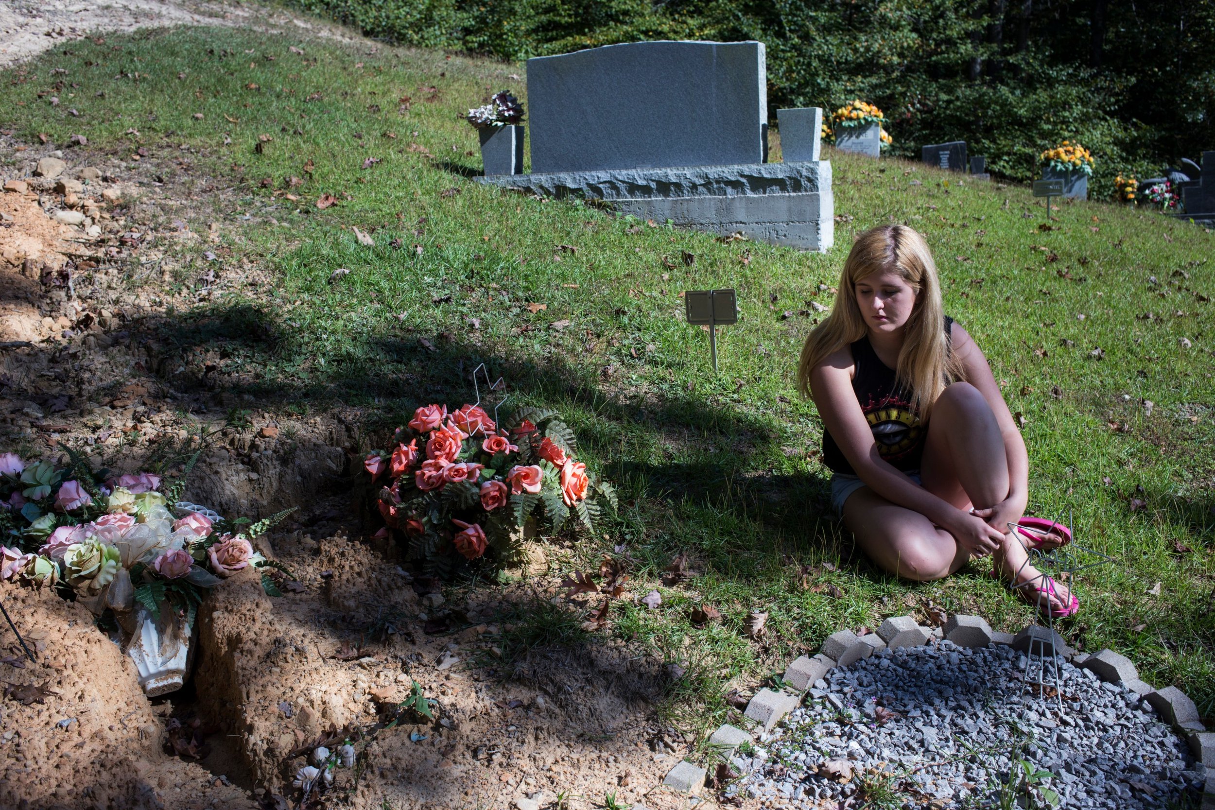  Lizzie Jones visits the grave of her parents in Belvinsville, Kentucky, on Sunday, September 24, 2017. Jones said she likes to sit in silence when she visits with her parents as she feels like she’s having an internal dialogue with them that is more