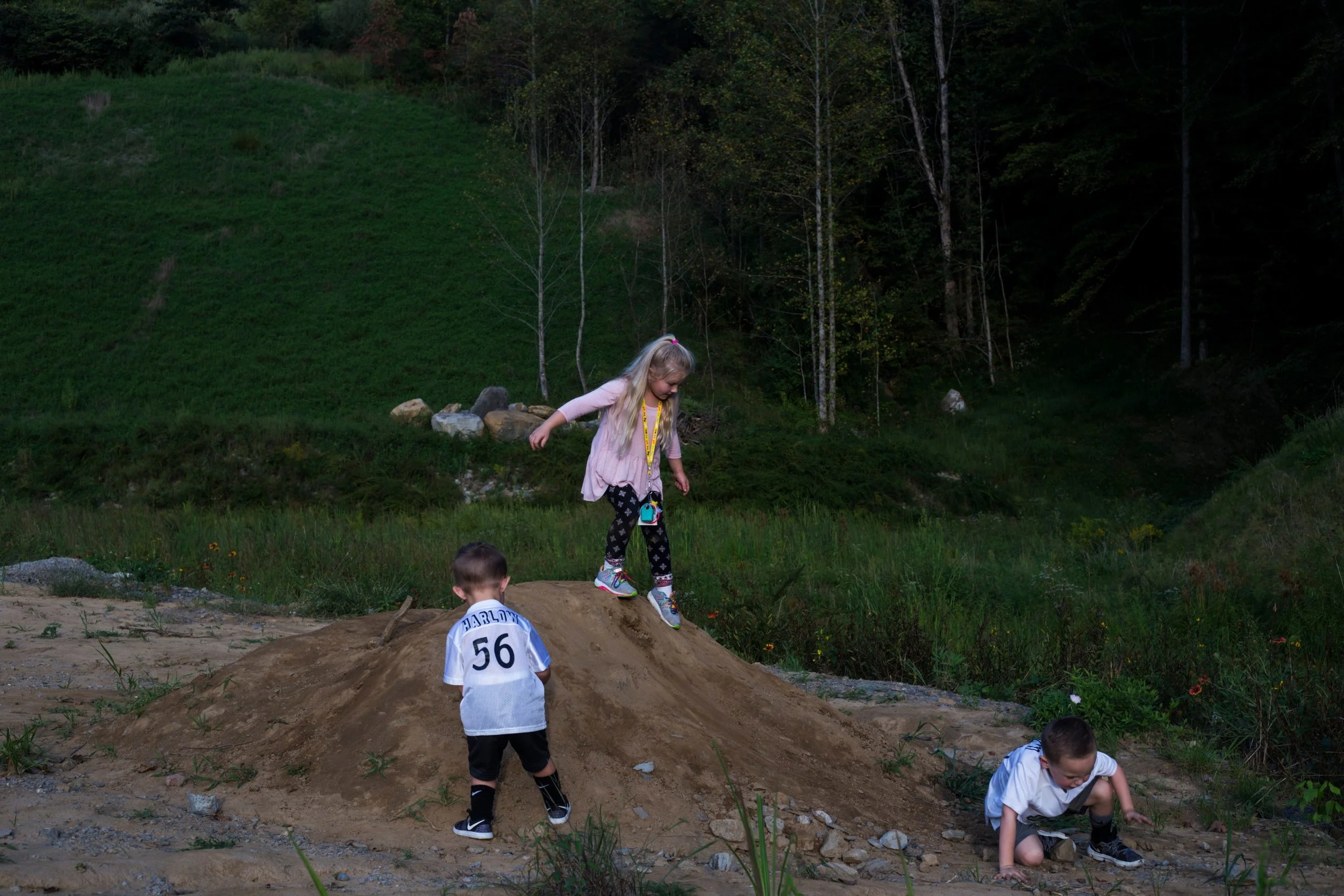 Carley Hatfield, 5, center, plays with Quinn Harlow, 5, right, and Paxton Harlow, 2, left, before a football game at Floyd Central High School in Langley, Kentucky, on Friday, September 22, 2017. (Photo by Brittany Greeson) 