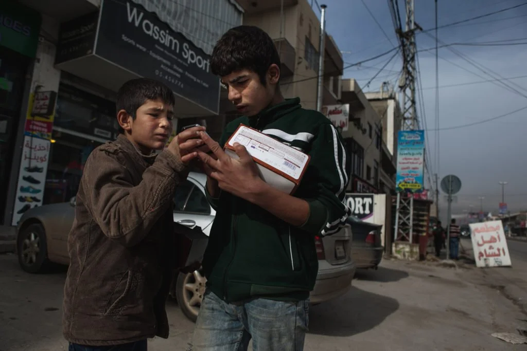  A young boy pushes a gas tank up a street in Azraq refugee camp, January 19, 2016. (Christopher Lee/GroundTruth) 