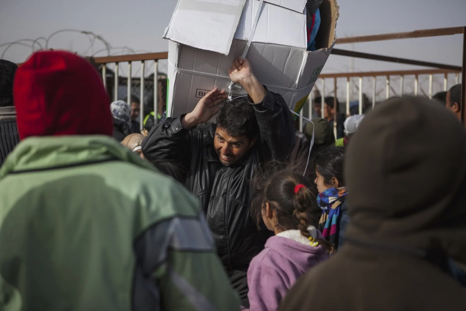  A man hauls a box of blankets during distribution hours in Zaatari refugee camp on January 18, 2016 . First opened on July 23, 2012 as a temporary settlement in Jordan for Syrians fleeing conflict, it has since turned into a permanent fixture resemb