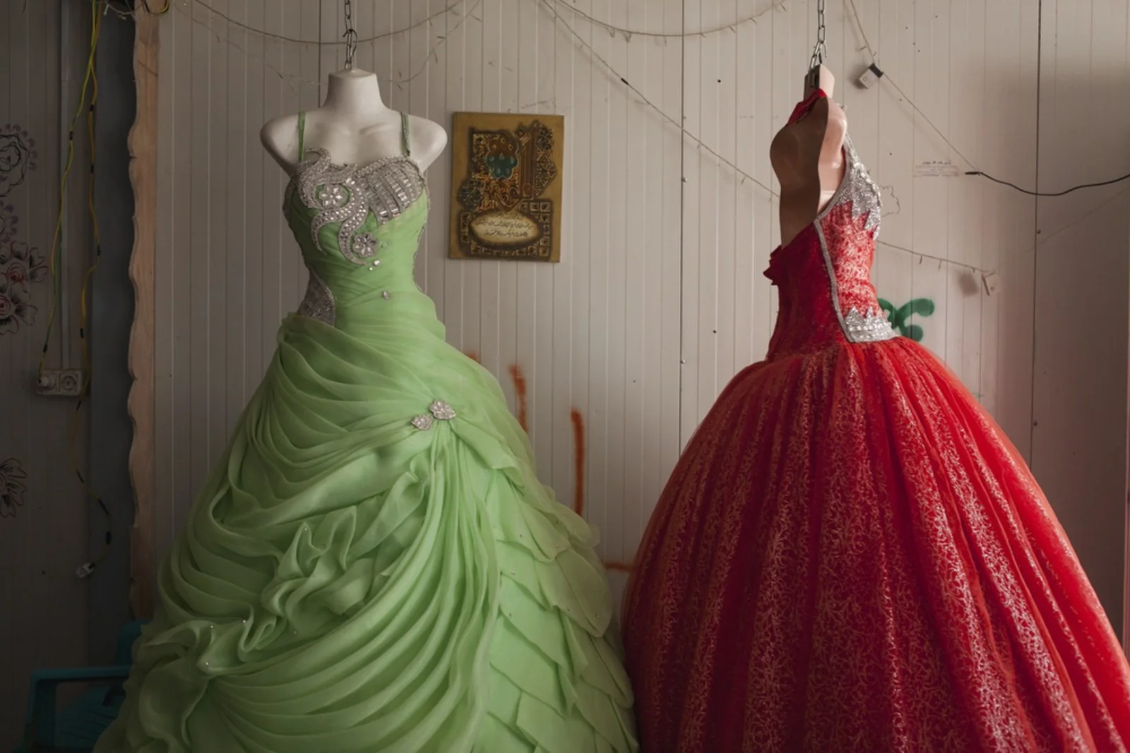  A view of a wedding dress shop in the main marketplace of Zaatari, nicknamed Champs-Elysée. The majority of the dresses are Syrian designed and made but are imported through Jordan. (Christopher Lee/GroundTruth)   