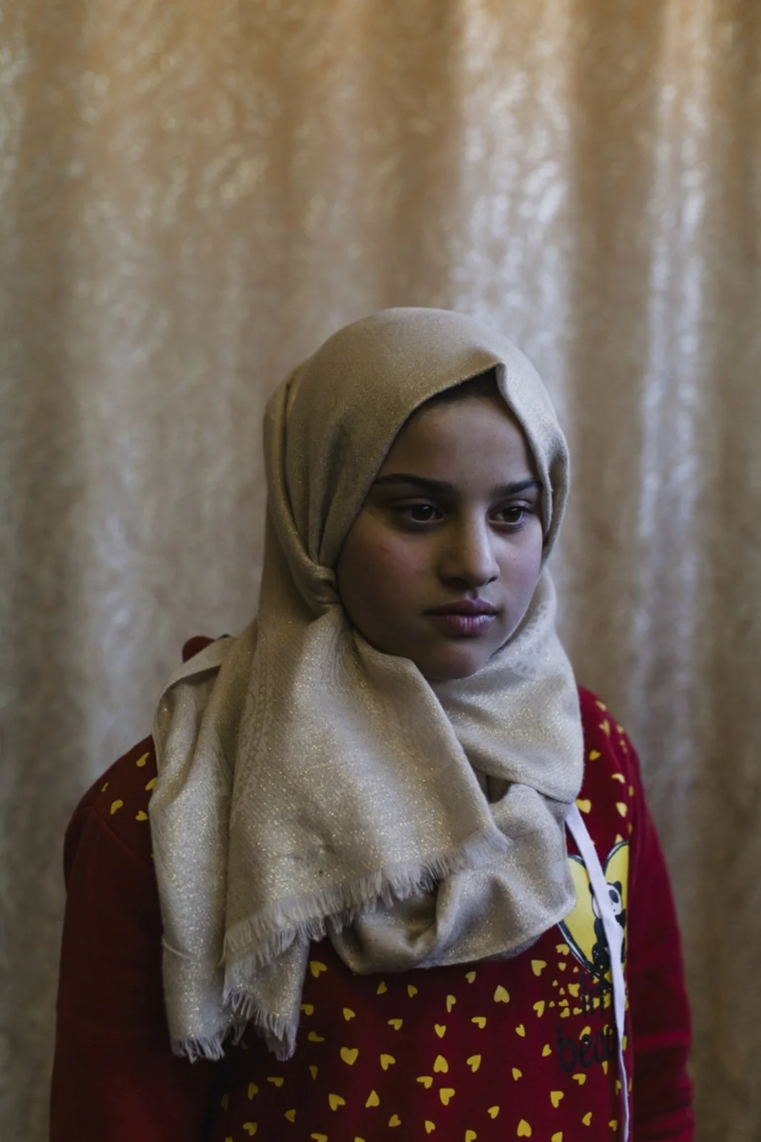  Asmaa Ayob, 13, a Syrian refugee from Daraa has been living in Amman, Jordan, for four years, poses for a portrait in the community center of Dar Al-Ihsan For Orphans, an organization that provides aid to orphaned children. Her father was killed dur