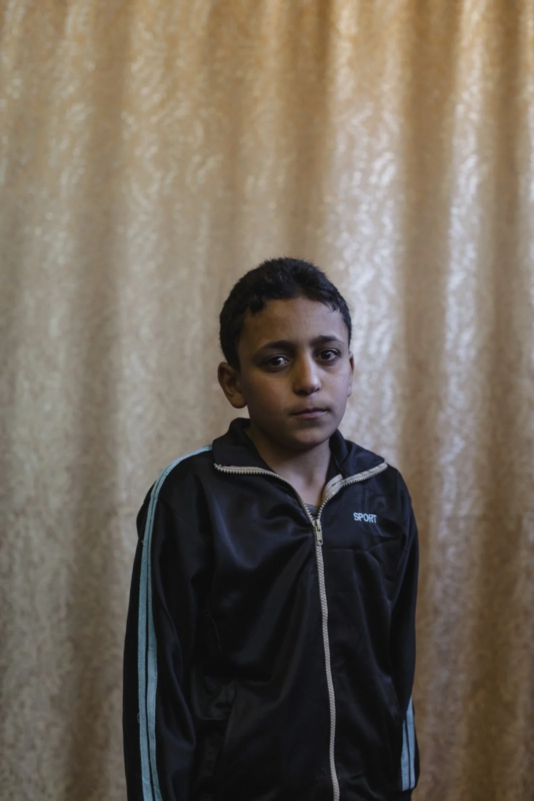  Mohamad Maher, 12, a Syrian refugee from Daraa, has been living in Amman, Jordan, for three years poses for a portrait in the community center room at Dar Al-Ihsan For Orphans. His mother died during childbirth. Dar Al-Ihsan For Orphans was started 