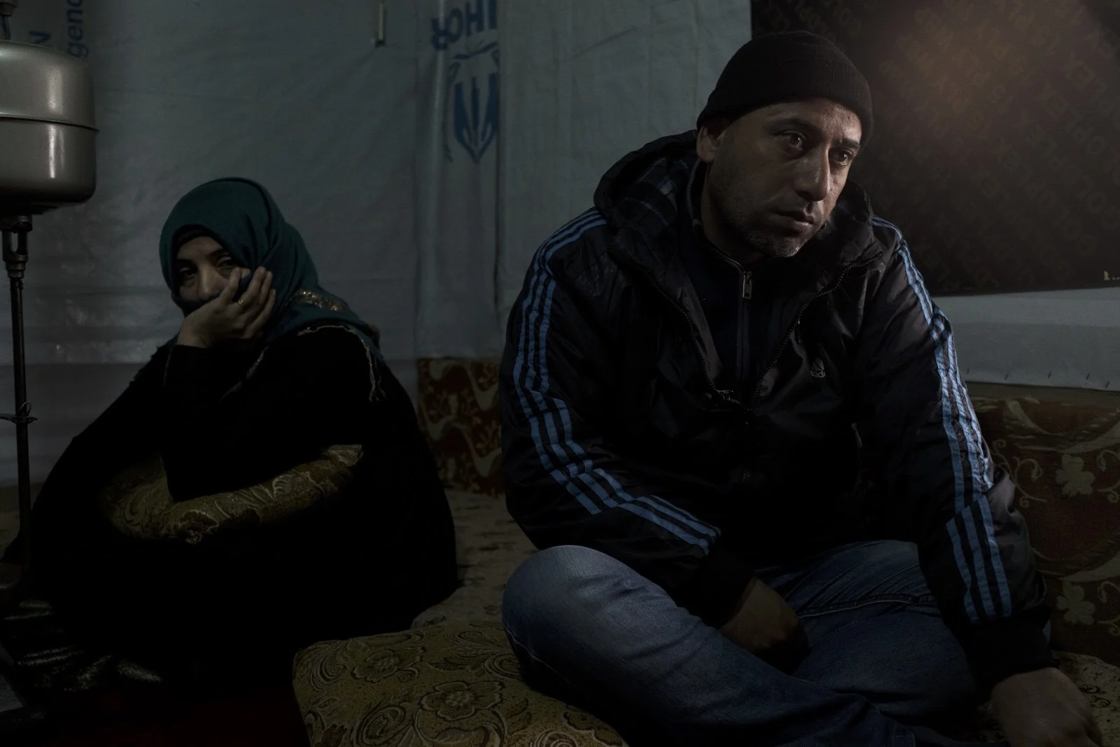  Abu Mohammad (right), sits with his wife, Um Mohammad (left) in their improvised tented settlement in the Bekaa Valley. Out of fear for their teenaged daughter’s safety, Abu Mohammad arranged for her to be married at the age of 13. But their daughte