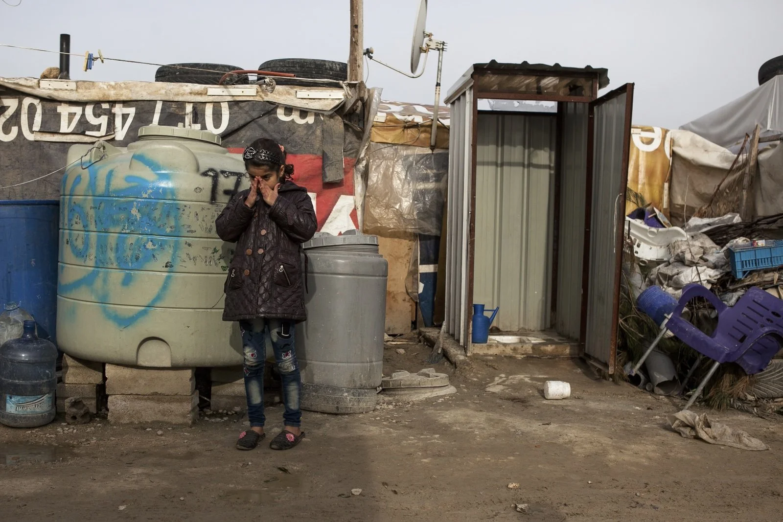  A young girl was found on a street in between the improvised tents in the Bekaa Valley. (Christopher Lee/GroundTruth) 