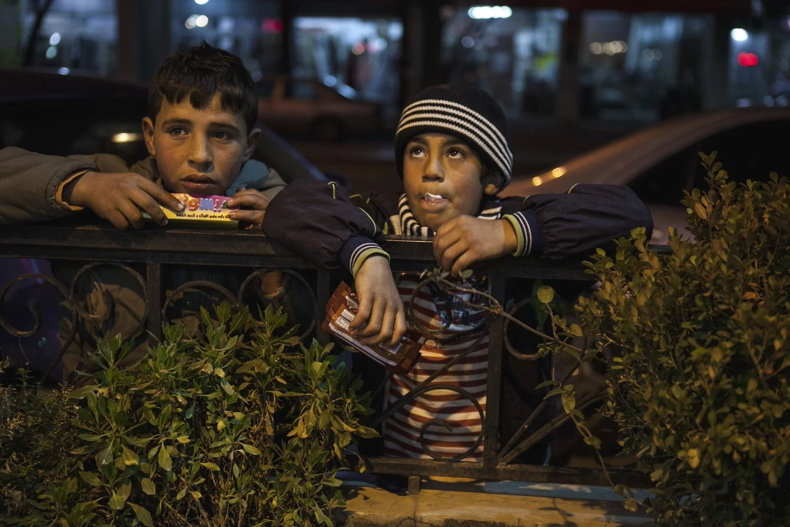  Mahmut (right), 8, a Syrian refugee from Homs, and another child waited for people to come out of a restaurant in the Bekaa Valley where they sell biscuits. (Christopher Lee/GroundTruth) 