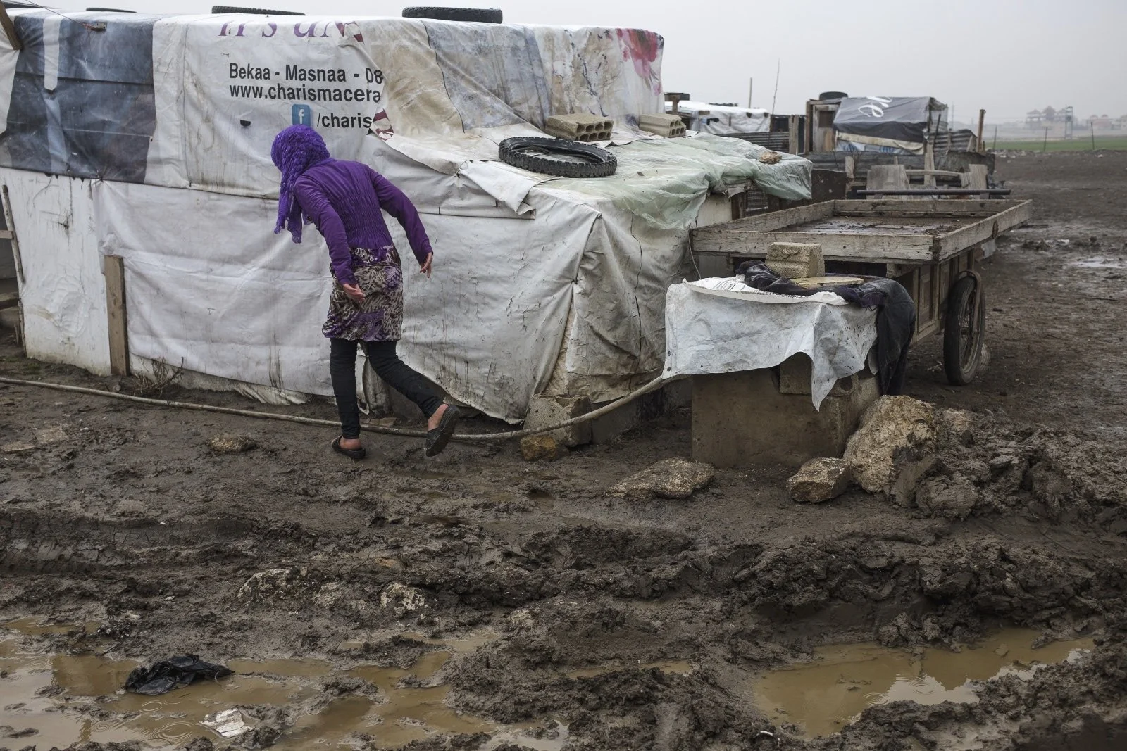  A young girl walks along her family’s improvised tented settlement in the Bekaa Valley. Combining the lack of aid for Syrian refugee communities, governmental restrictions and growing tensions between the Syrian and Lebanese community, there is litt