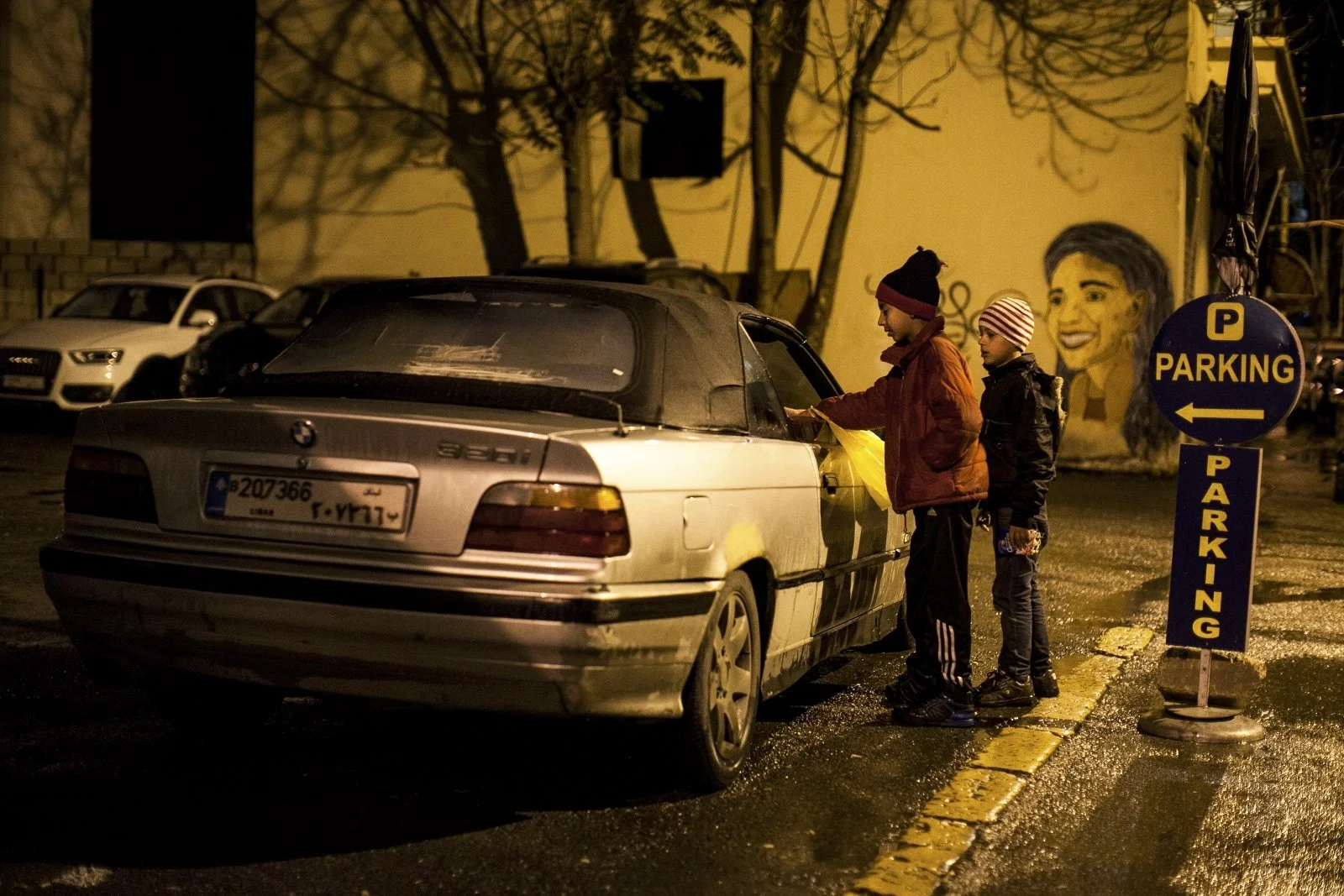  Nasar (left), 11, and his brother Ali, 9, Syrian refugees from Aleppo, approach a car near Hamra Street in Beirut, attempting to sell packages of peanuts. Among the 1.8 million Syrian refugees in Lebanon, women and children remain the most vulnerabl