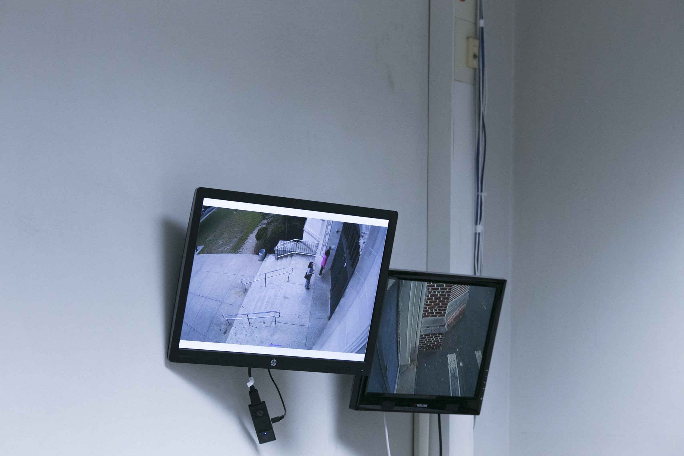  People are seen waiting outside the front doors to the High School of Commerce via a security system in the main office in Springfield, Mass., on Friday, September, 8, 2017. (Photo by Brittany Greeson) 
