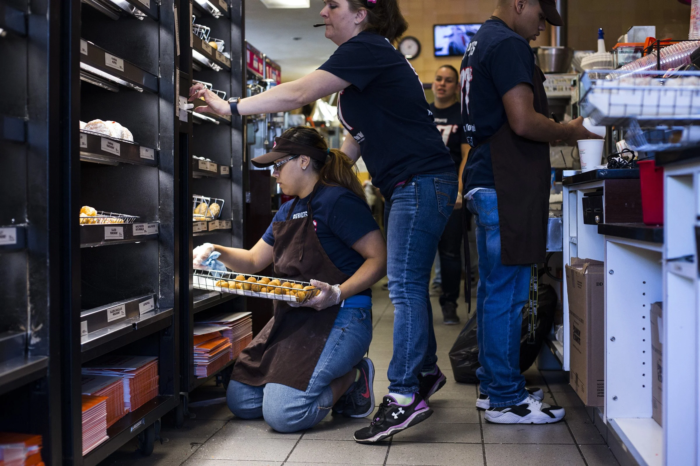  Jennilease Gomez, 17, shifts trays of donuts at the Dunkin Donuts where she works on the weekends in South Hadley, Mass., on Saturday, September, 10, 2017. Gomez said she originally got the job in order to help support her brothers, 11 and 7, as her