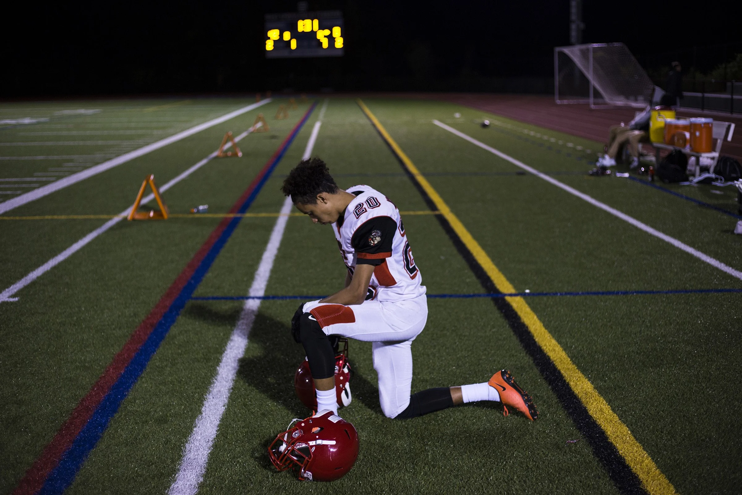  Wide receiver, David Porche Mayes, of the High School of Commerce kneels as he waits for the clock to run out as his team faces a 0-42 half-time score during a game in West Springfield, Mass., on Friday, September, 8, 2017. (Photo by Brittany Greeso