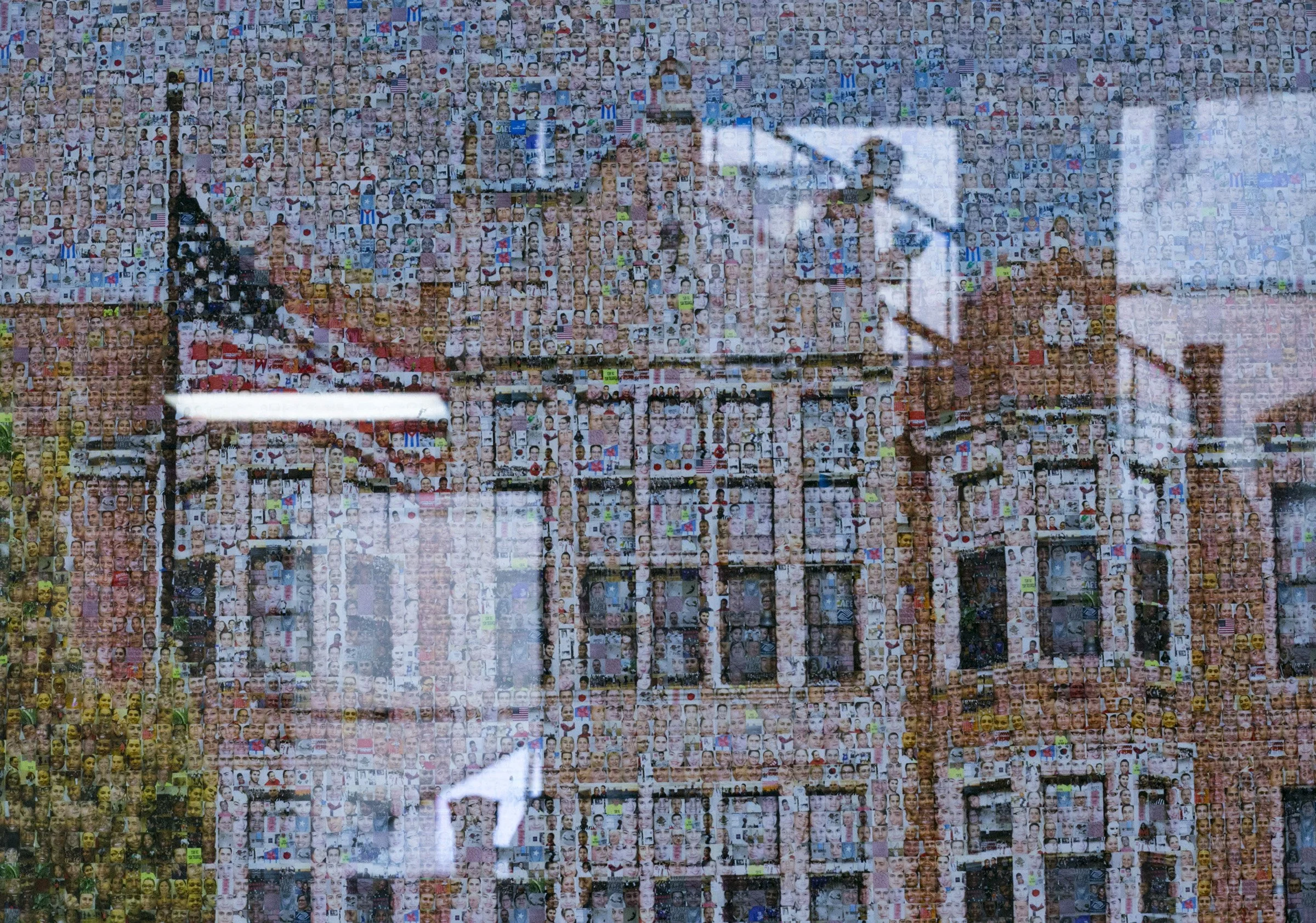  A student is reflected in a poster showing the student faces of the High School of Commerce within the building’s likeness in Springfield, Mass., on Friday, September, 8, 2017. (Photo by Brittany Greeson) 