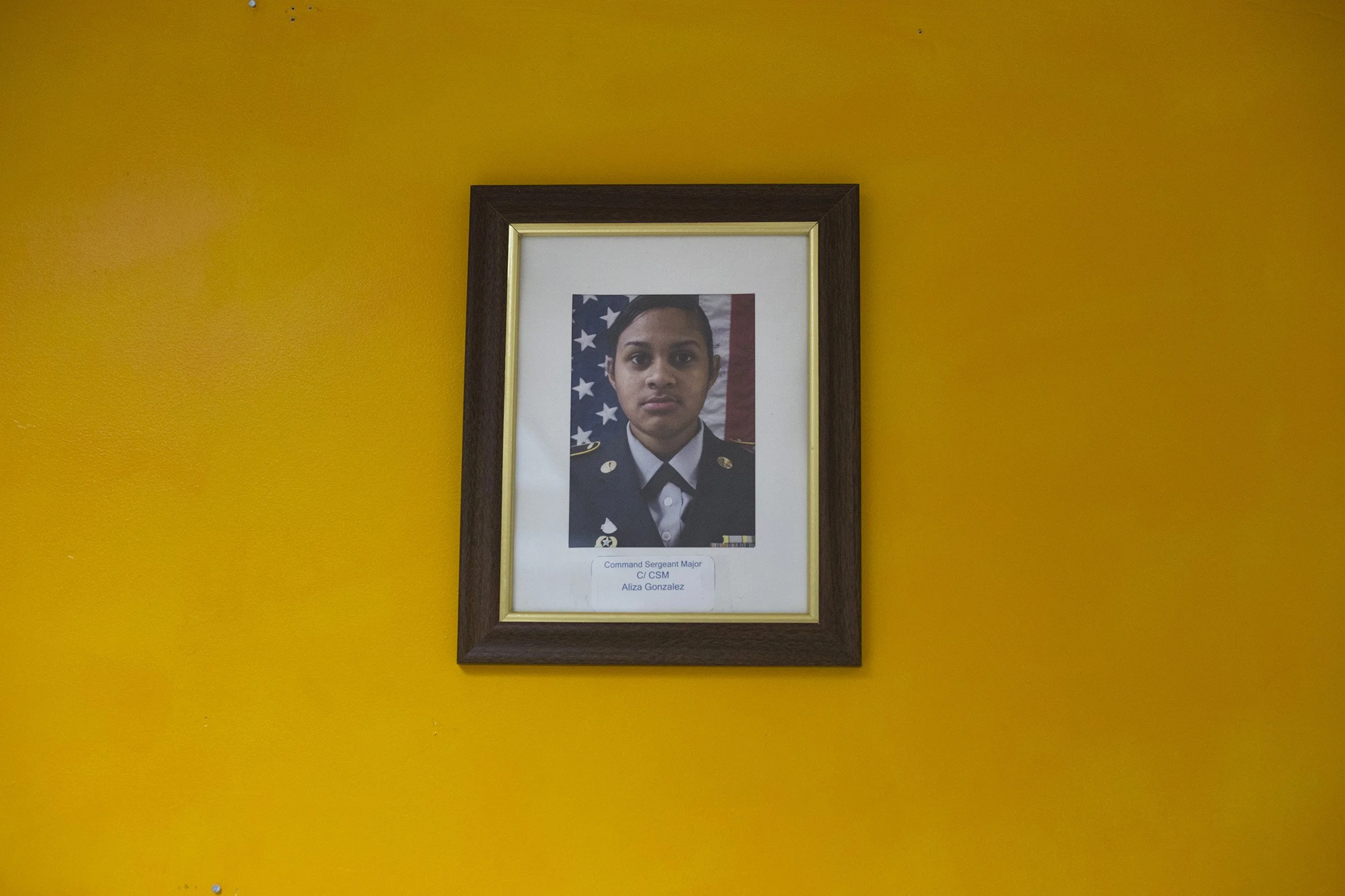  A single photograph featuring Command Sergeant Major Aliza Gonzalez, 17, hangs on the wall in a JROTC classroom in Springfield, Mass., on Monday, September, 11, 2017. (Photo by Brittany Greeson) 