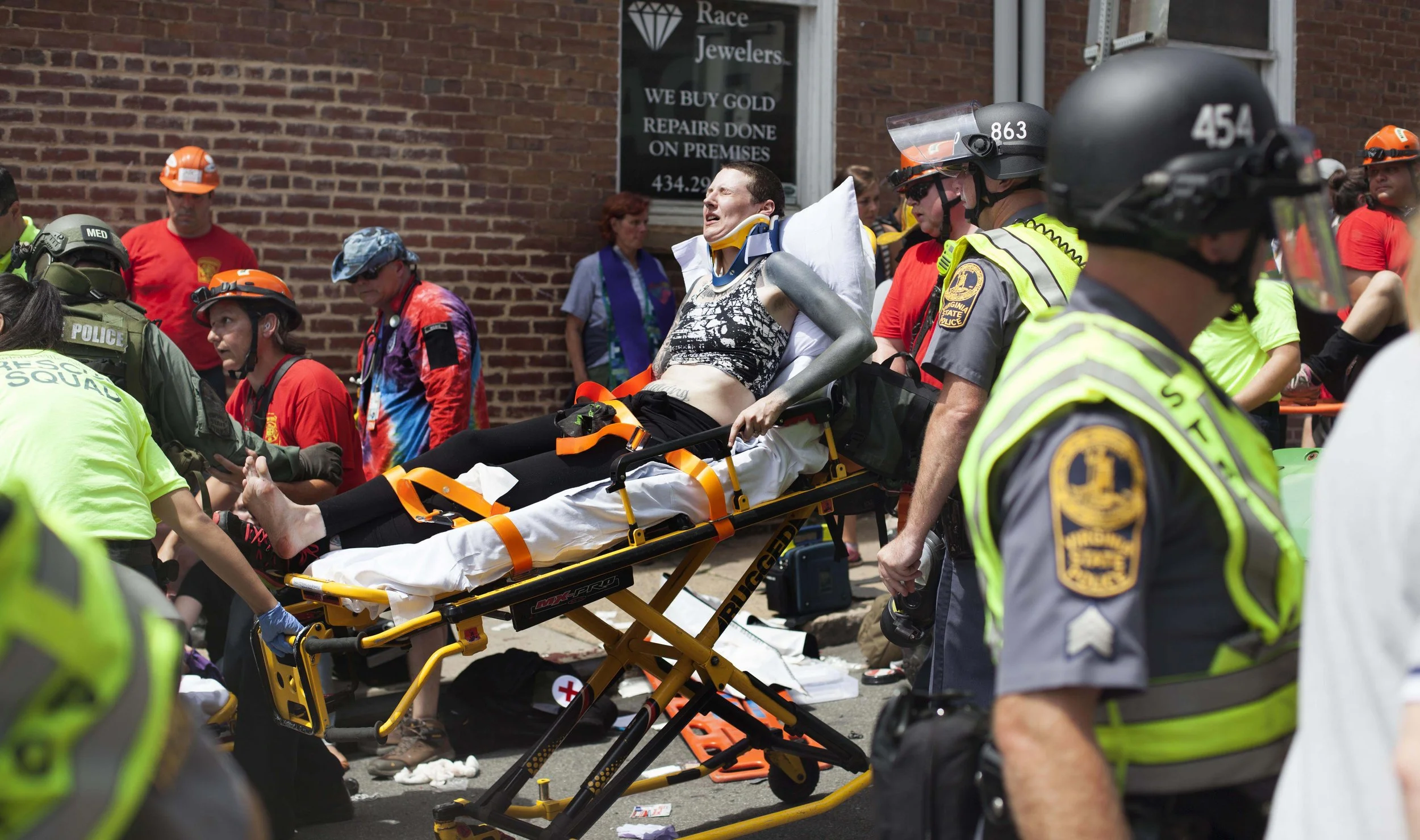  EMS and street medics treat counter protesters after a driver, later identified by police as 20 year old James Alex Fields, Jr., plowed his car into the group. 32 year old Heather Heyer died, and 19 others were wounded in the attack. August &nbsp;12