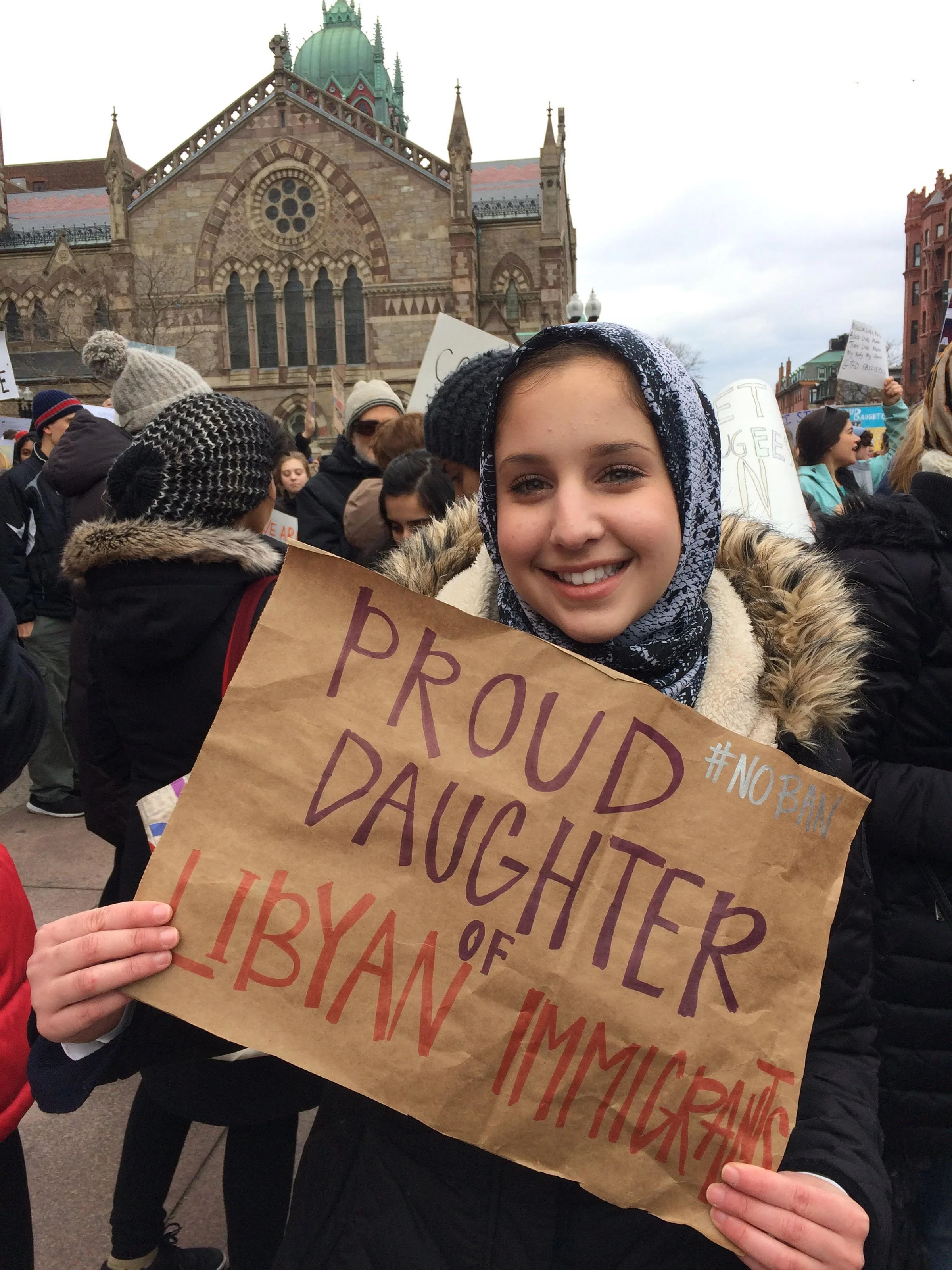  Noor Traina, 17, holds a sign that reads “Proud daughter of Libyan immigrants” in Boston’s Copley Square. “One of the countries in the ban is Libya and that means my family won’t be able to visit me in the States. The only way that I could see them 
